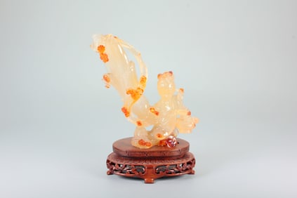 AN AGATE FLYING LADY SCATTERING FLOWERS
