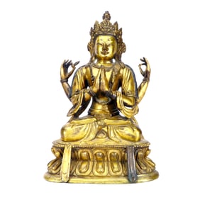 A GILT-BRONZE FOUR-ARMED GUANYIN SEATED FIGURE