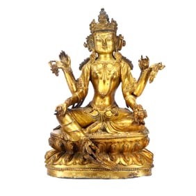 A GILT-BRONZE SIX-ARMED GODDESS FIGURE