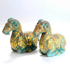 A GOLD-INLAID BRONZE RAM-FORM PAPERWEIGHT