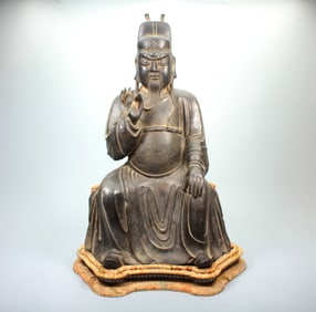 A BRONZE GUANDI SEATED FIGURE