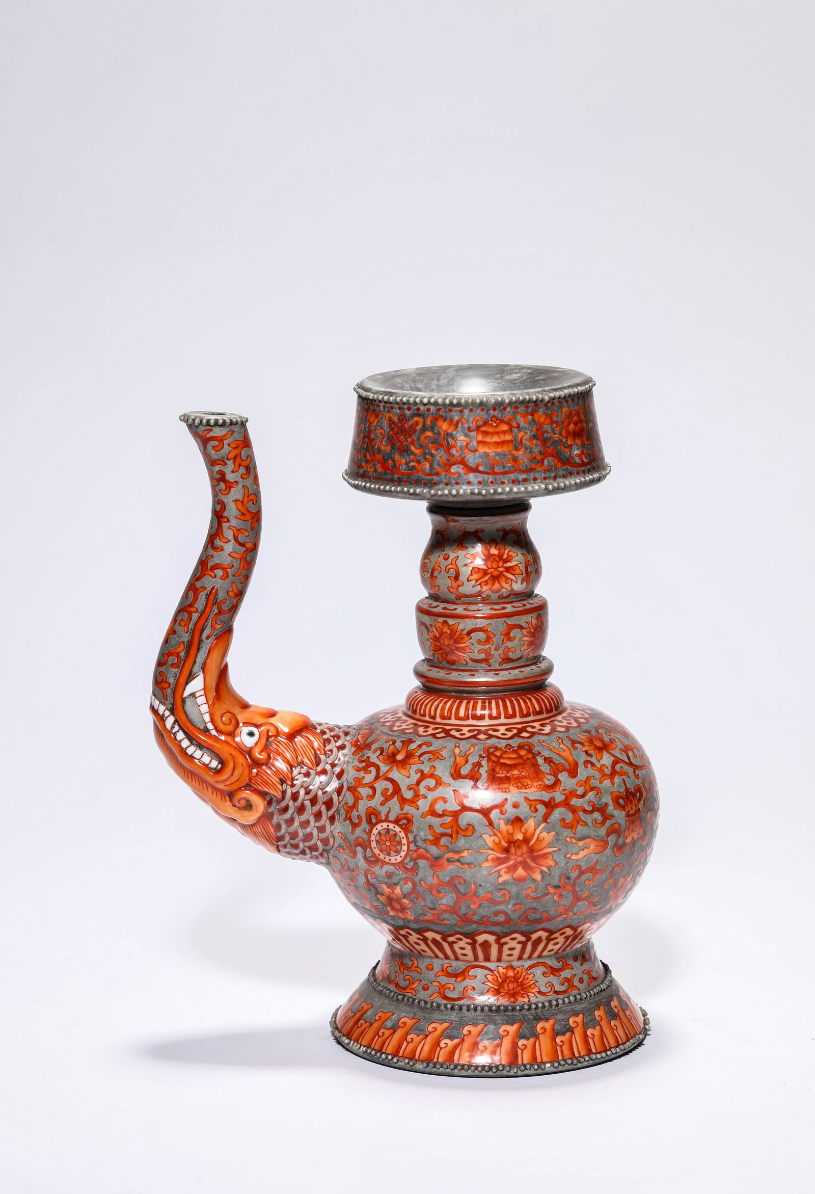 An Iron-Red 'Eight Buddhist Emblems' 'Bumpa' Vessel: An Iron-Red 'Eight Buddhist Emblems' 'Bumpa' Vessel (15.3 x 10.4 x 20cm)