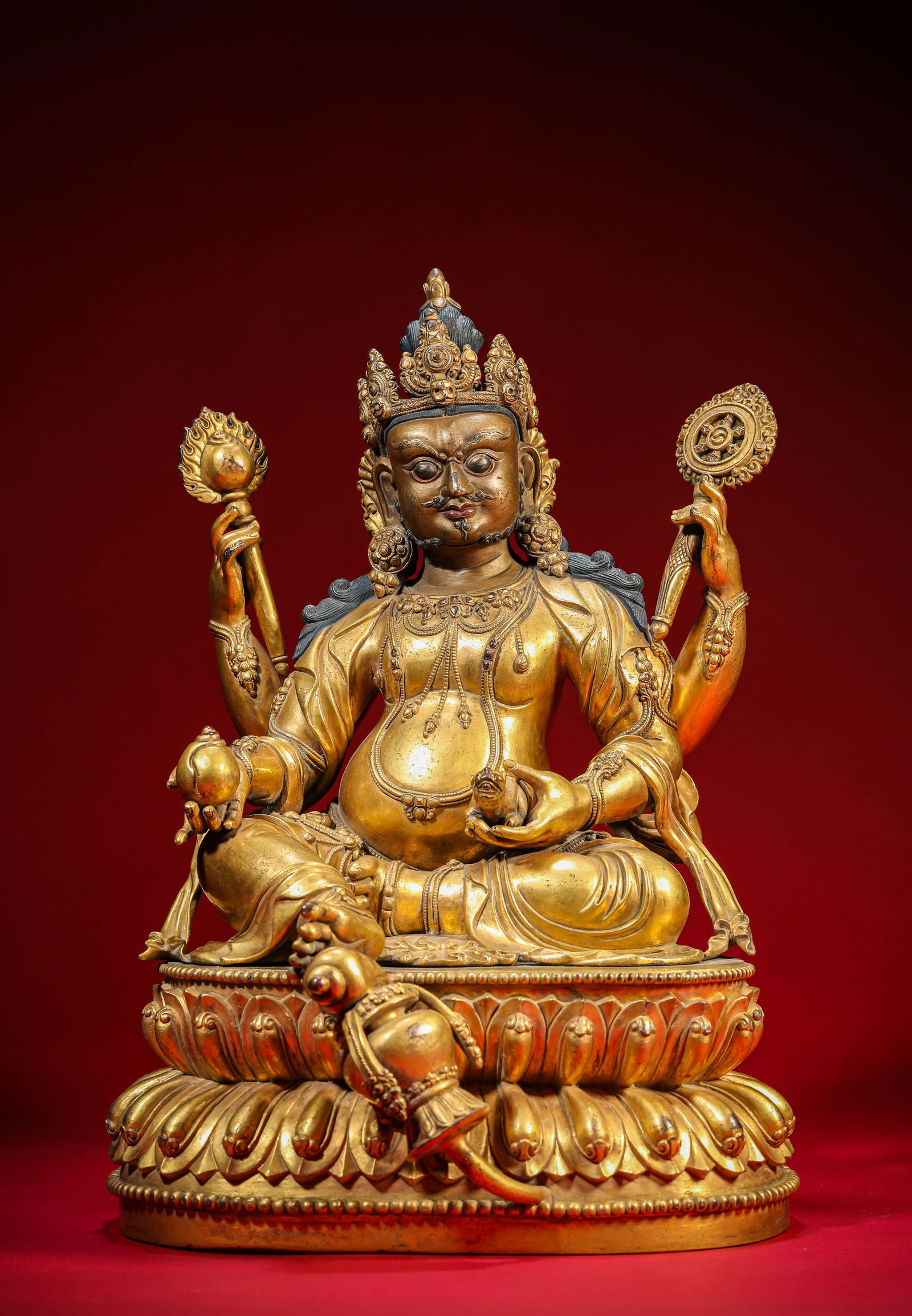 A Gilt-Bronze Figure of Four-Armed Yellow Jambhala: A Gilt-Bronze Figure of Four-Armed Yellow Jambhala (24.3 x 23.2 x 35cm,Weight 11.1kg)