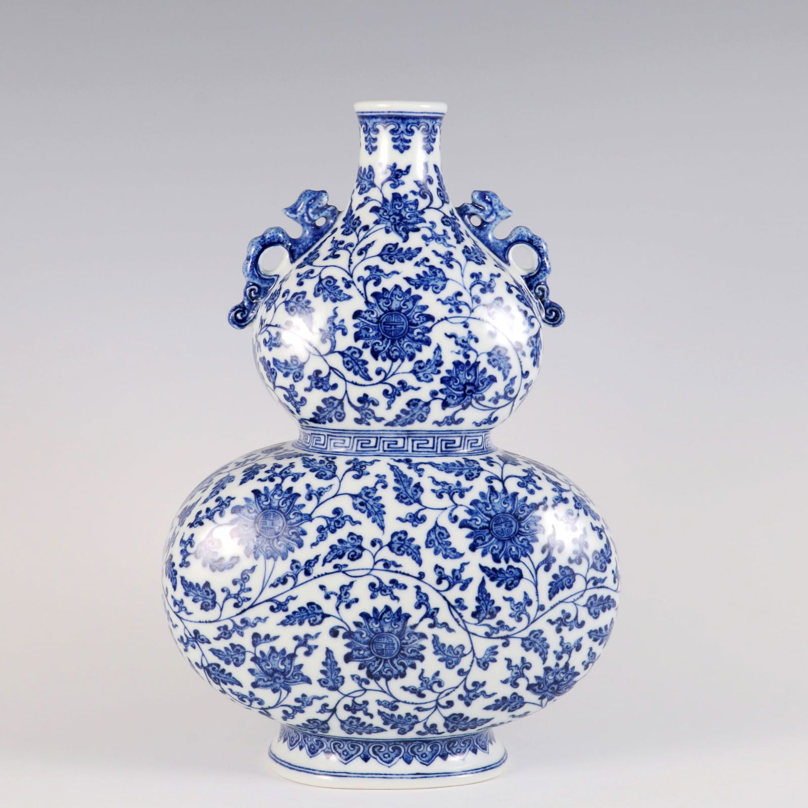 AN UNDERGLAZE-BLUE 'INTERLOCKING LOTUS AND CHILONG' DOUBLE-GOURD VASE (1 of 9)