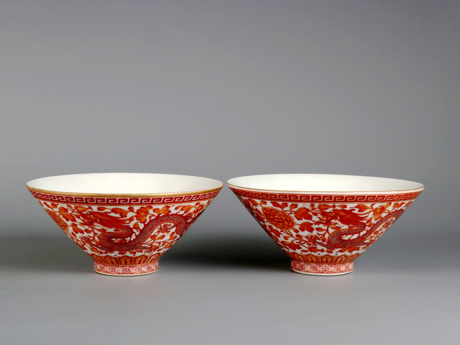 AN IRON-RED 'DRAGON, PHOENIX AND PEONY' CONICAL BOWL (1 of 9)