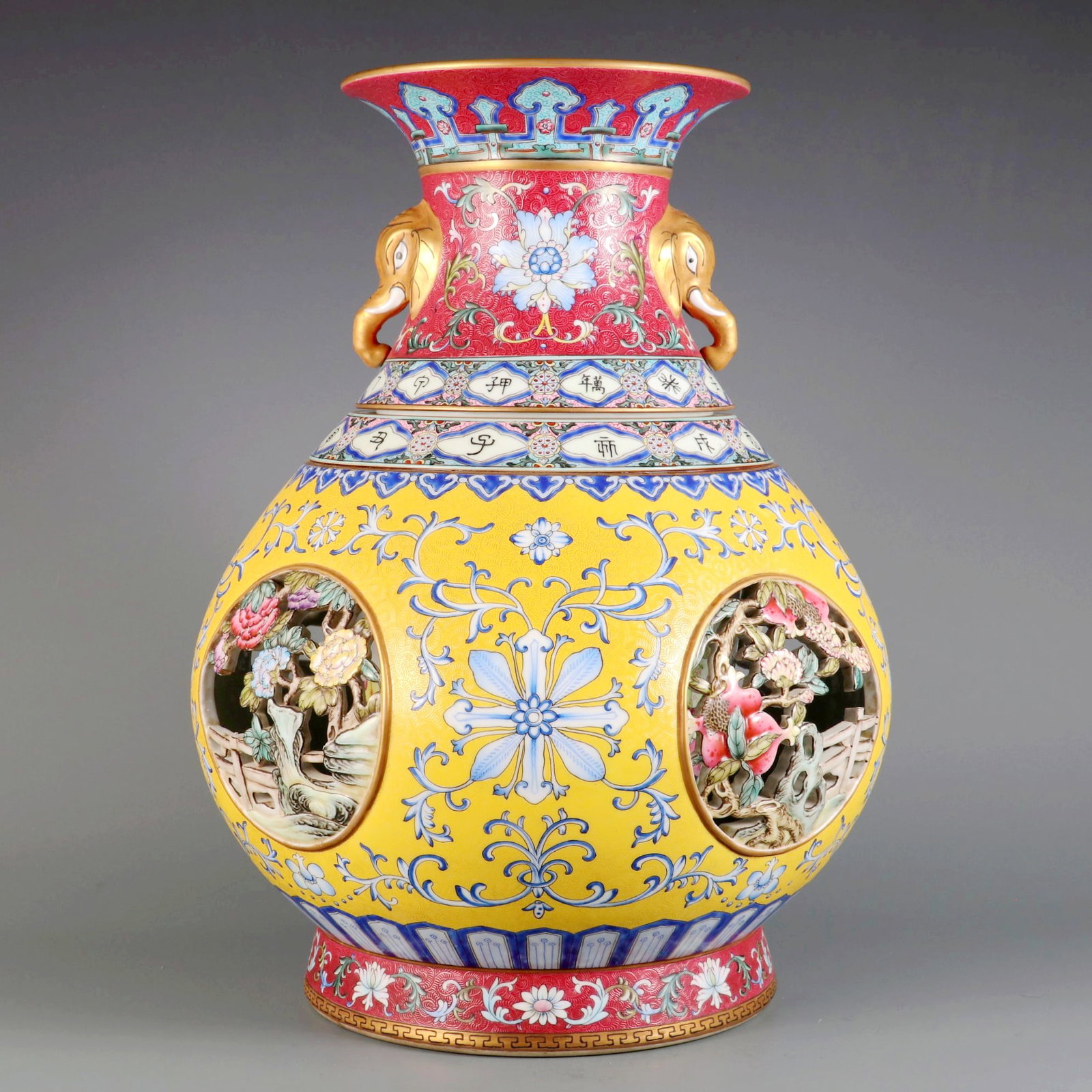 AN ENAMEL 'INCISED PA HUA, RESERVE FOUR SEASON FLOWERS, OPENWORK' ELEPHANT-HANDLE REVOLVING VASE (1 of 10)