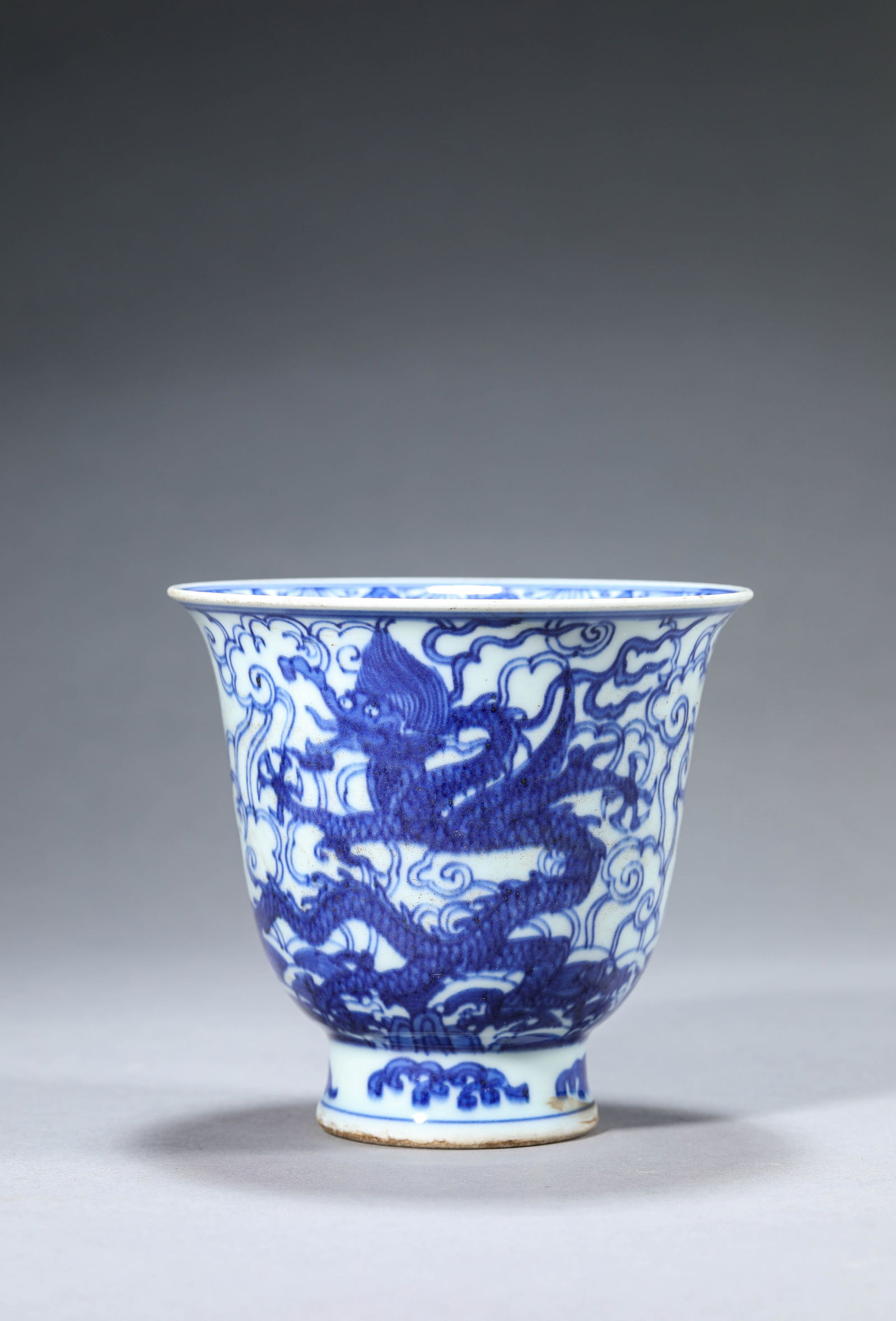 A Blue and White 'Dragon and Clouds' Cup: A Blue and White 'Dragon and Clouds' Cup (12.2 x 11.3 cm)
