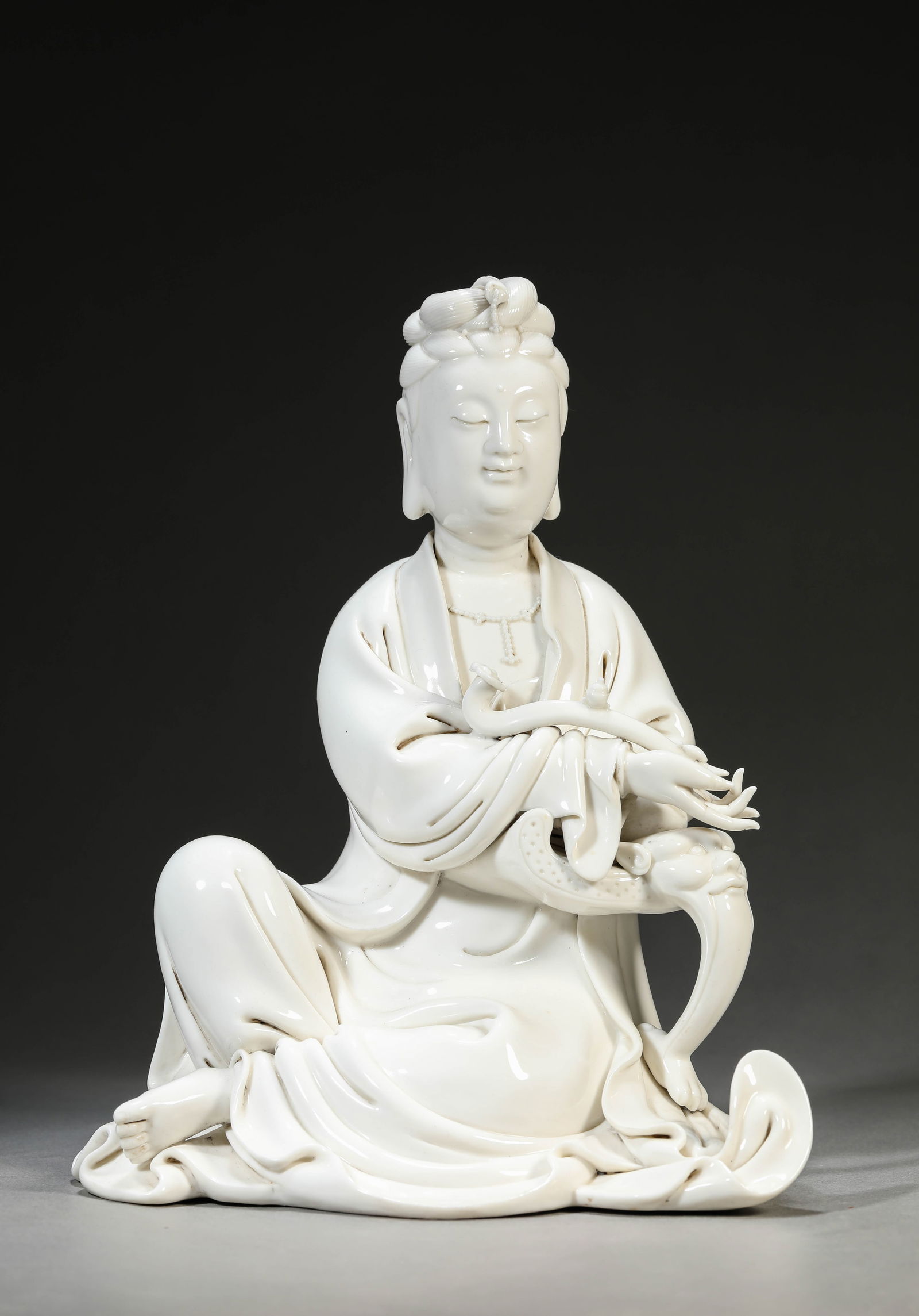 A Dehua-Type 'Ruyi-Holding' Figure of Avalokiteshvara: A Dehua-Type 'Ruyi-Holding' Figure of Avalokiteshvara (21.2 x 15.5 x 26 cm)
