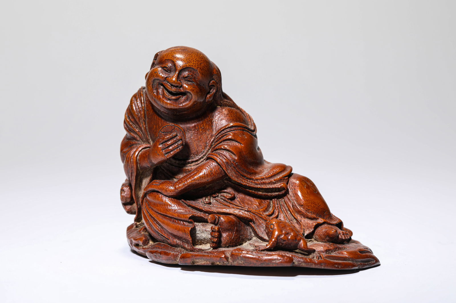 A Bamboo 'Carved Liu Hai Playing with a Toad': A Bamboo 'Carved Liu Hai Playing with a Toad' (15.3 x 11.9 x 11.1 cm)