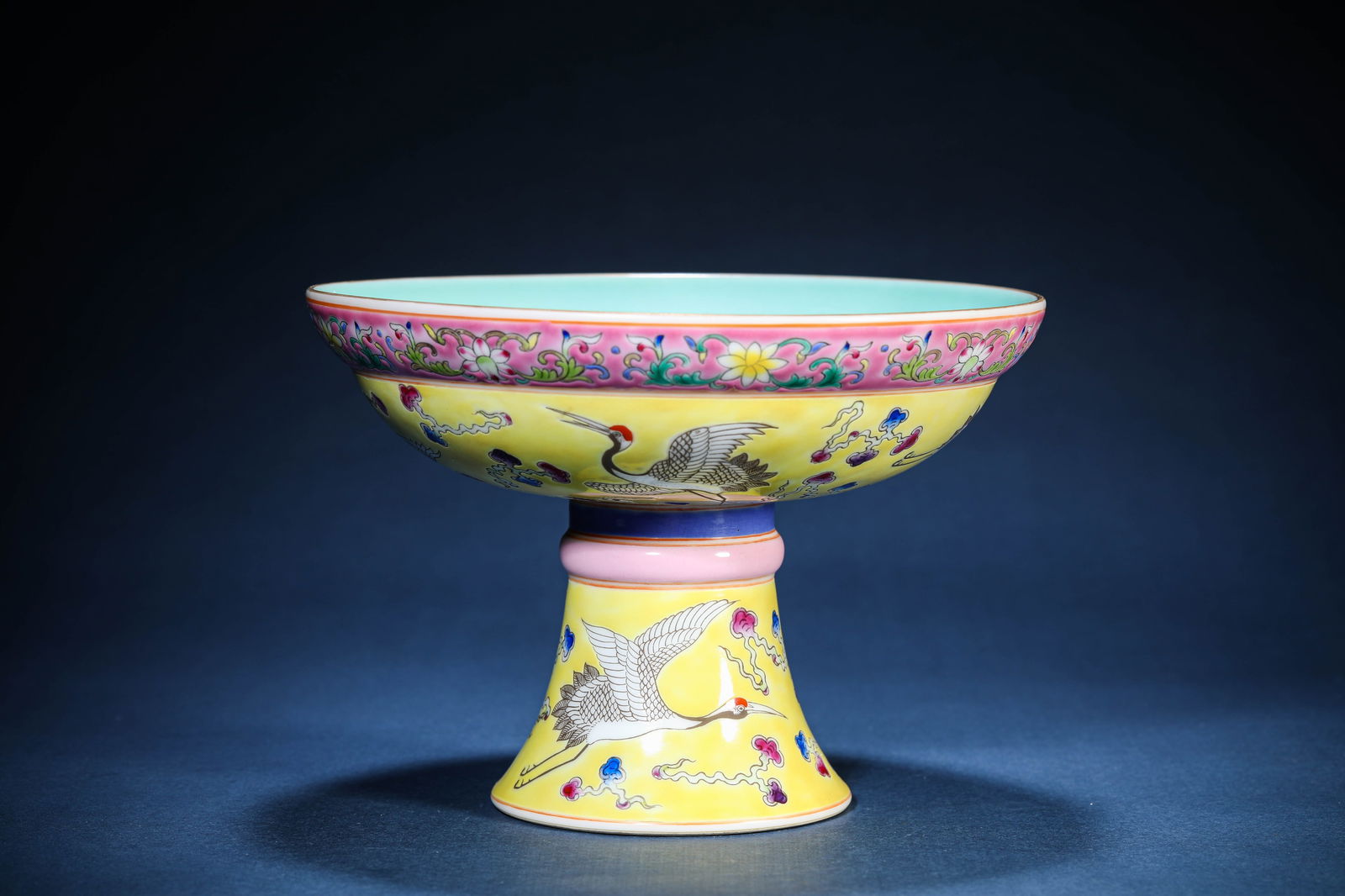A Yellow-Ground Wucai 'Auspicious Clouds and Cranes' Stem Dish: A Yellow-Ground Wucai 'Auspicious Clouds and Cranes' Stem Dish (20.1 x 14.1 cm)