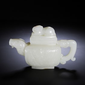 A CHINESE HOTAN JADE TEAPOT WITH RAM-HEAD SPOUT AND BEAST FINIAL