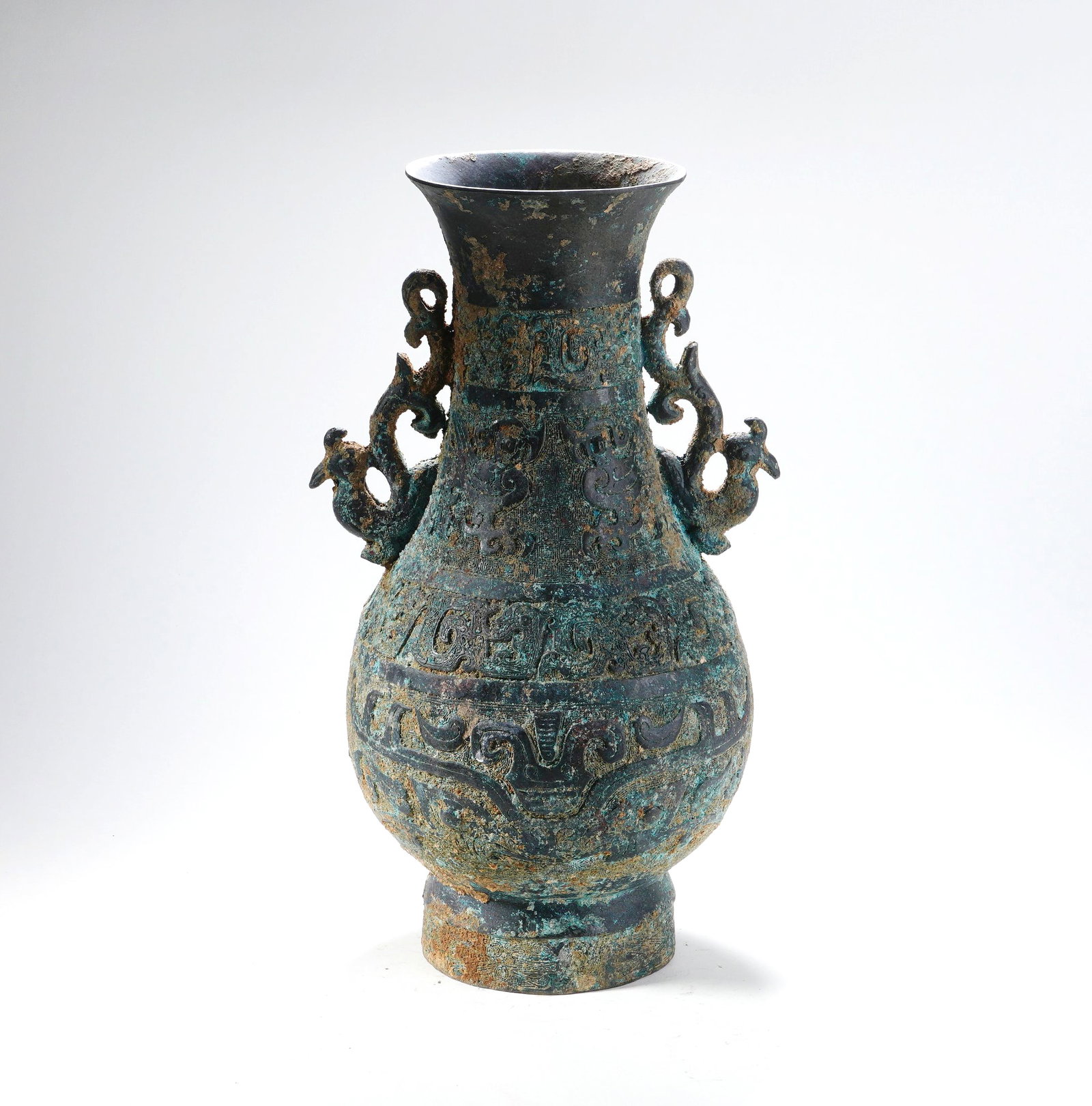 A BRONZE POT WITH DOUBLE DRAGON HANDLES AND RING-HOLDING EARS: A BRONZE POT WITH DOUBLE DRAGON HANDLES AND RING-HOLDING EARS H:34CM,W:20CM