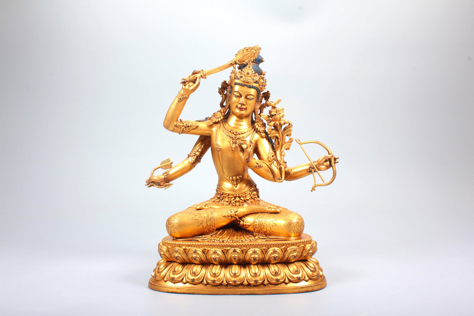 A GILT BRONZE FIGURE OF FOUR-ARMED MANJUSHRI: A GILT BRONZE FIGURE OF FOUR-ARMED MANJUSHRI H:19.6CM,W:16.6CM