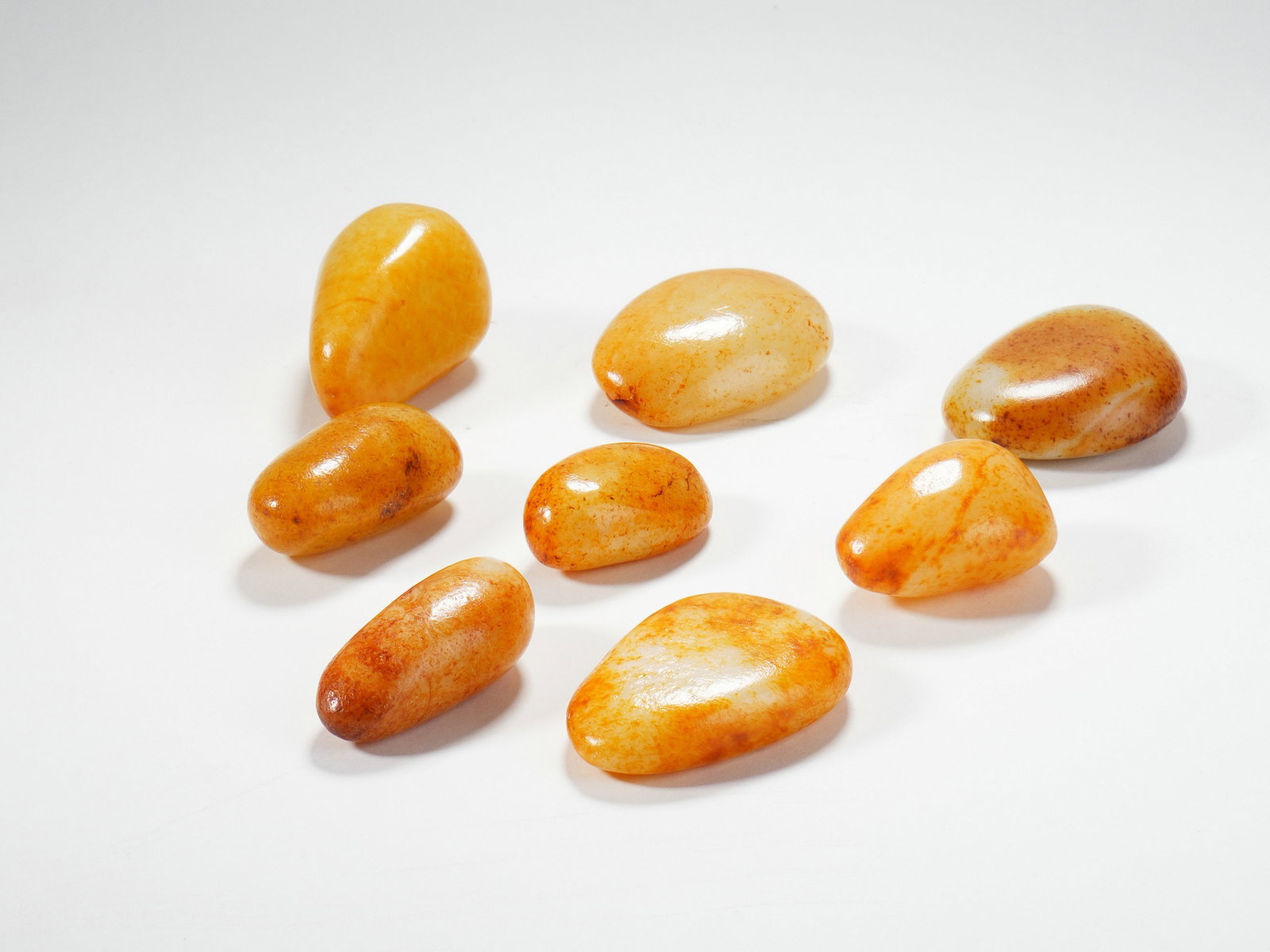 A GROUP OF HETIAN WHITE JADE RAW STONES WITH RED SKIN: A GROUP OF HETIAN WHITE JADE RAW STONES WITH RED SKIN H:3CM,W:5.5CM