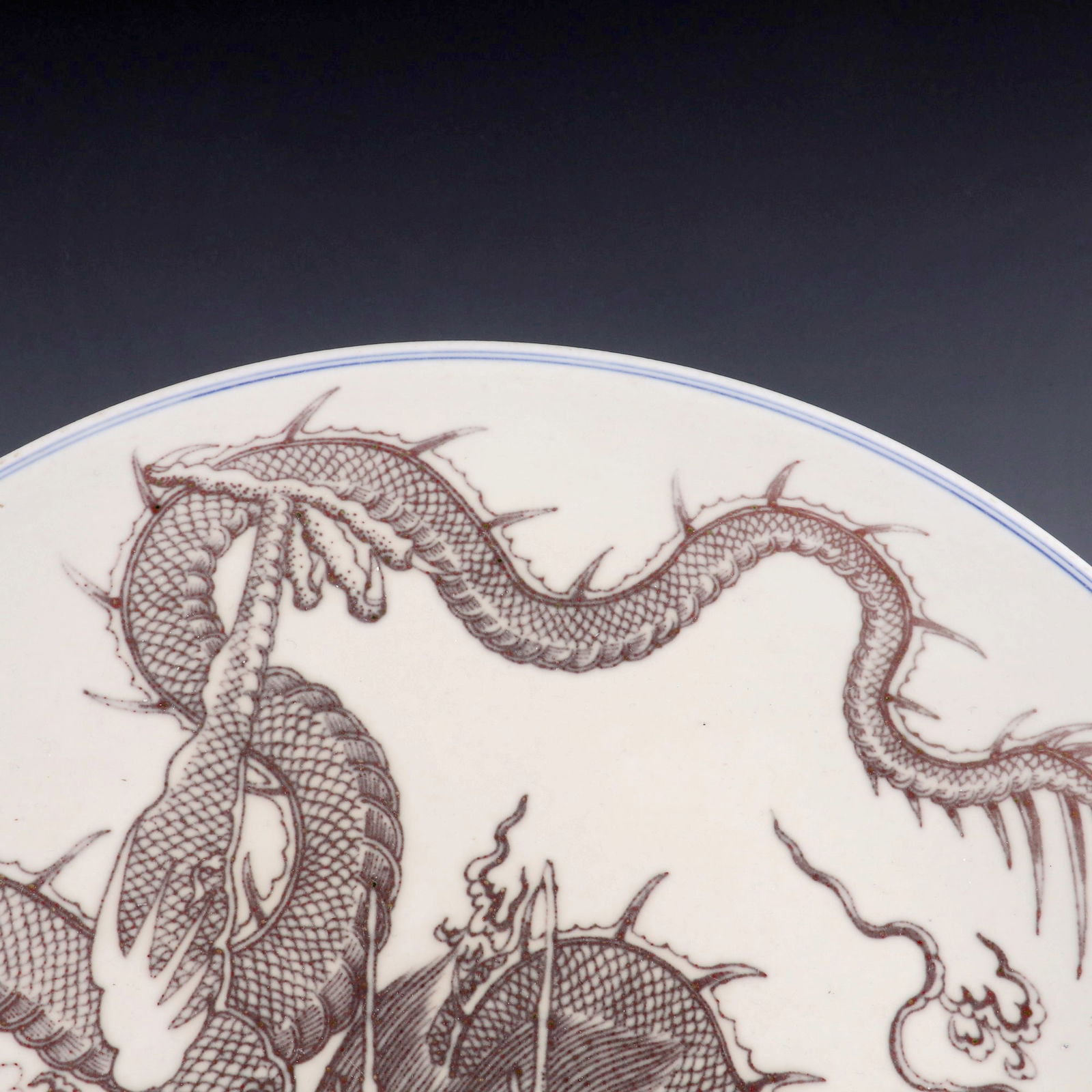 A LARGE UNDERGLAZED RED PLATE WITH DOMINANT DRAGON PATTERN - 2