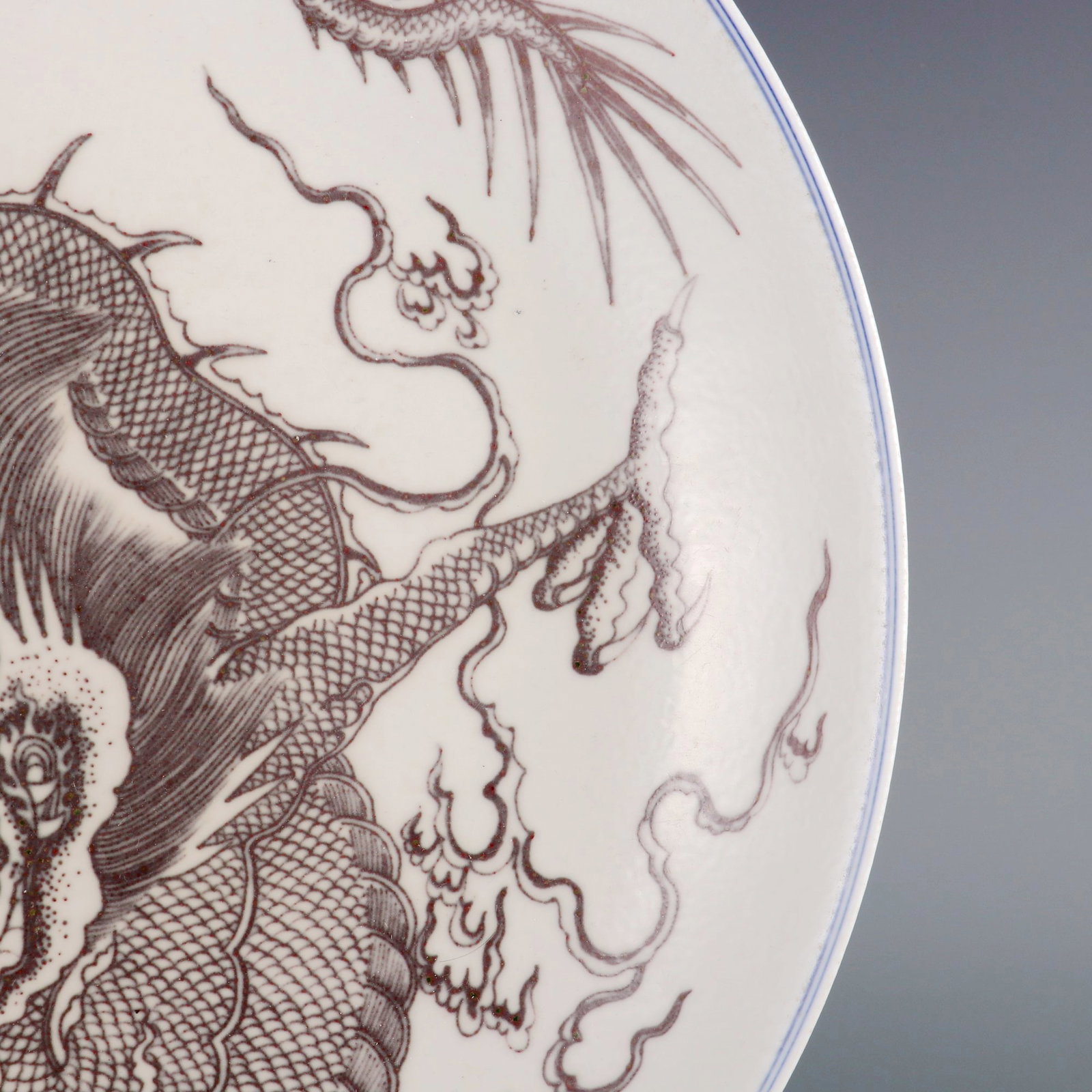 A LARGE UNDERGLAZED RED PLATE WITH DOMINANT DRAGON PATTERN - 4
