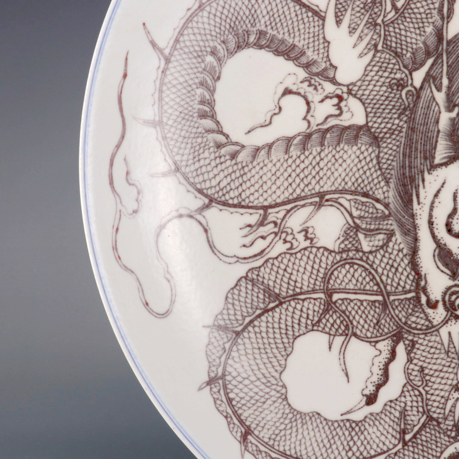 A LARGE UNDERGLAZED RED PLATE WITH DOMINANT DRAGON PATTERN - 5