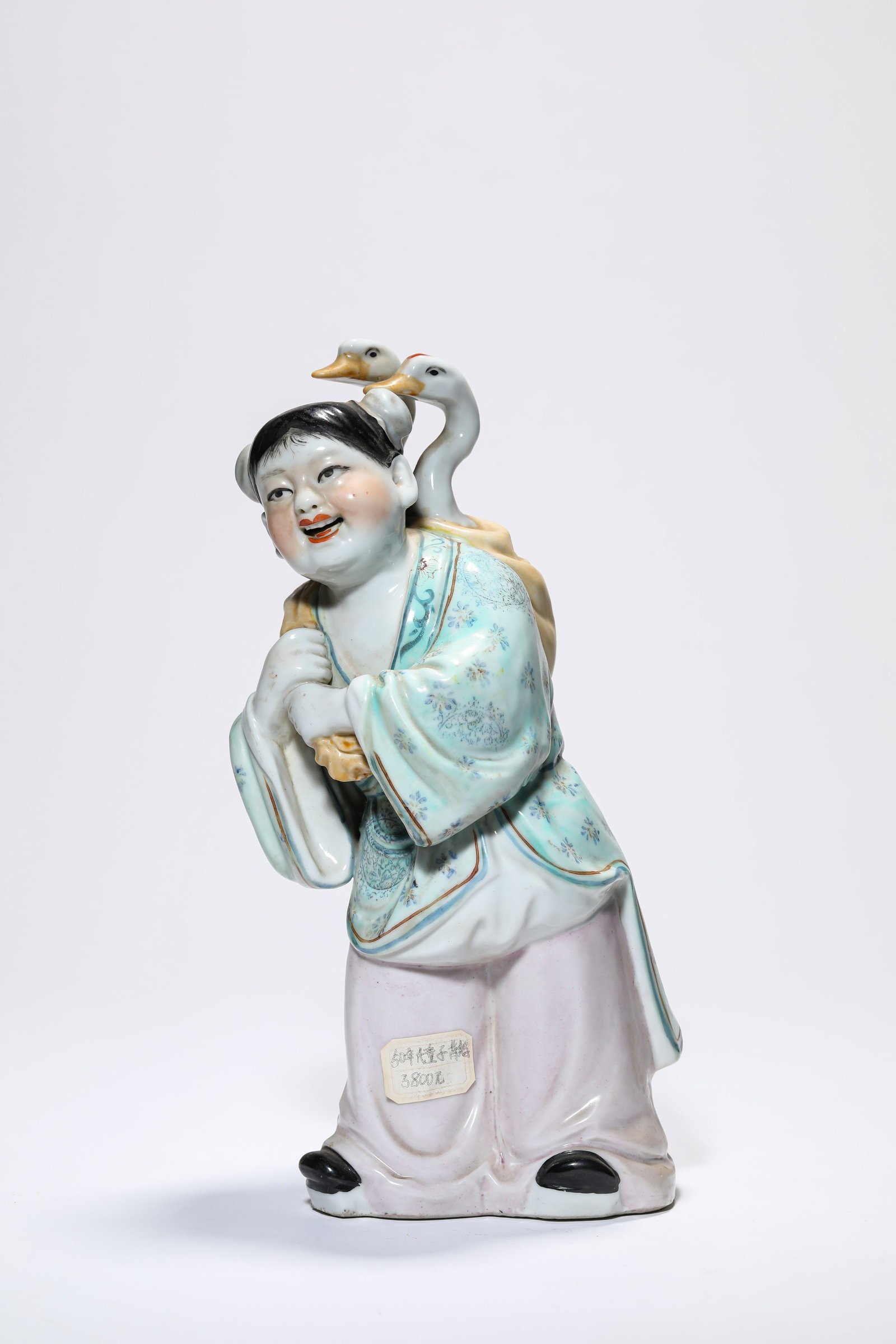A PORCELAIN FIGURE: A PORCELAIN FIGURE Description: Dimensions: Length: 11.5 cm x Width: 10 cm x Height: 25.5 cm. All measurements are approximate.