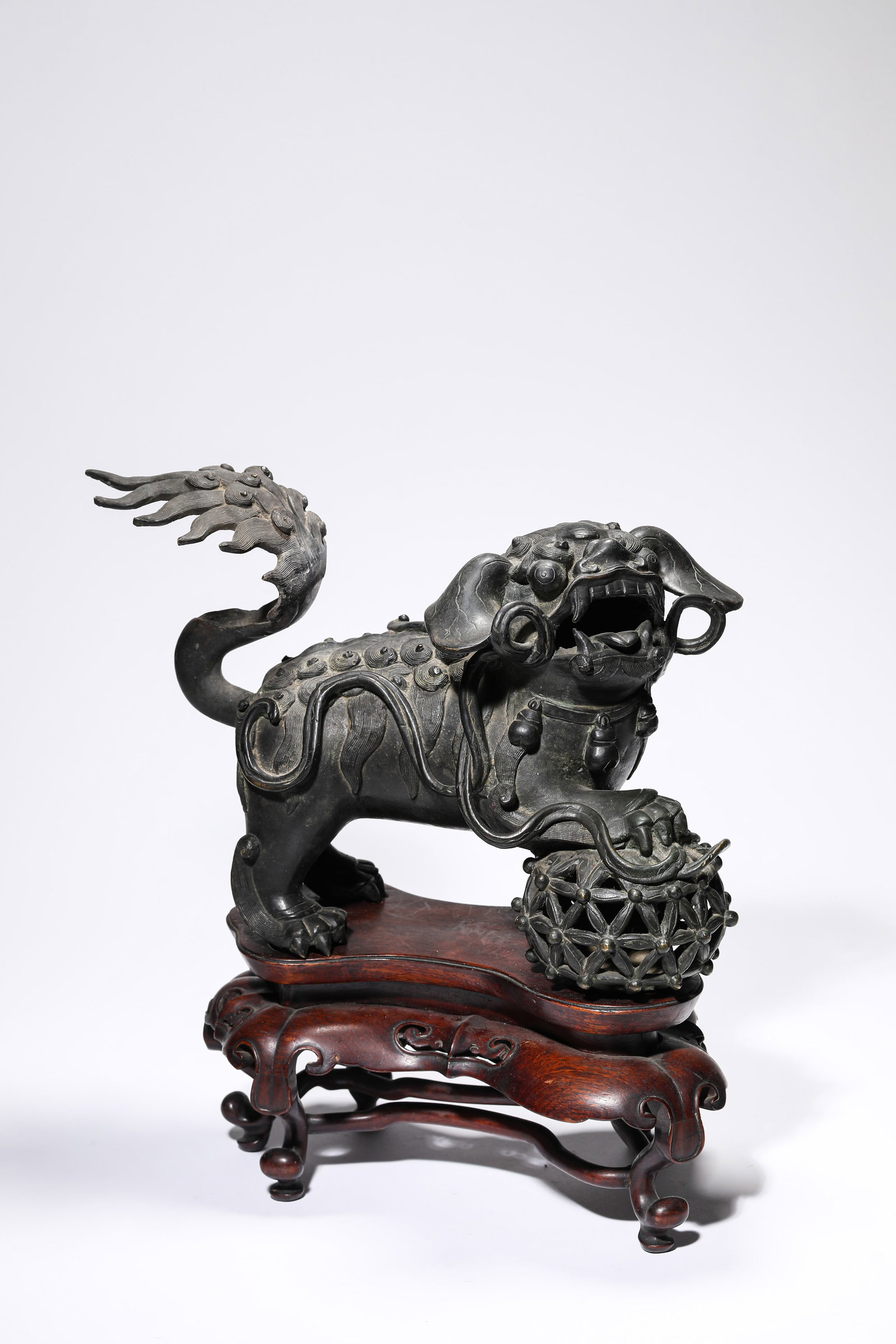 A BRONZE ‘LION PLAYING WITH A BALL’: A BRONZE ‘LION PLAYING WITH A BALL’ Description: Dimensions: Weight: 6200 g. Length: 32 cm x Width: 15.7 cm x Height: 22 cm. All measurements are approximate.