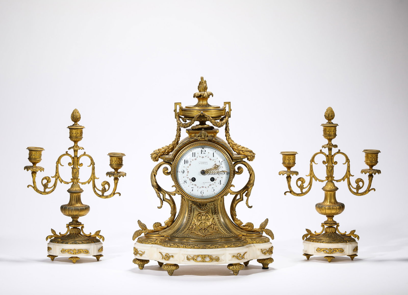 A GROUP OF GILT-BRONZE BELL AND CANDLEHOLDERS: A GROUP OF GILT-BRONZE BELL AND CANDLEHOLDERS Description: Dimensions: Weight: 12400 g. Length: 29 cm x Width: 15.3 cm x Height: 40 cm. Length: 21.6 cm x Width: 8.8 cm x Height: 33.5 cm.All
