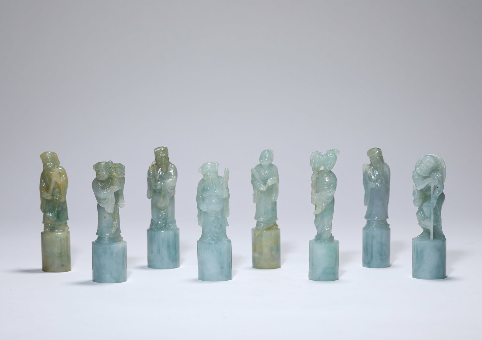 A GROUP OF JADEITE ‘CARVED EIGHT IMMORTALS’ ‘INFORMAL’ SEALS: A GROUP OF JADEITE ‘CARVED EIGHT IMMORTALS’ ‘INFORMAL’ SEALS Description: Dimensions: Width: 2.7 cm x Height: 9.7 cm. Width: 2.7 cm x Height: 9.2 cm. All measurements are approximate.