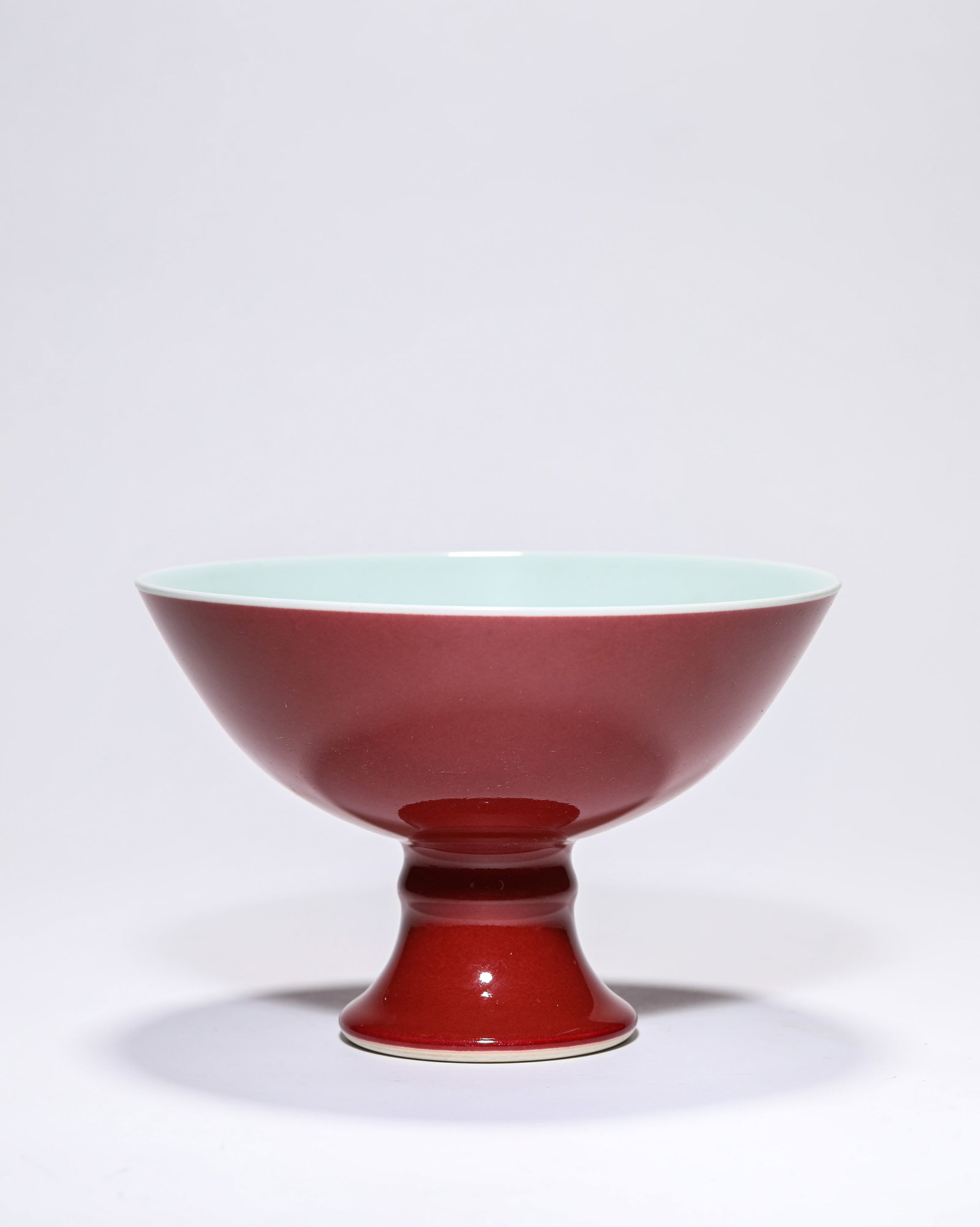 A RED-GLAZED STEM BOWL: A RED-GLAZED STEM BOWL Description: Dimensions: Width: 18.4 cm x Height: 12.5 cm. All measurements are approximate.