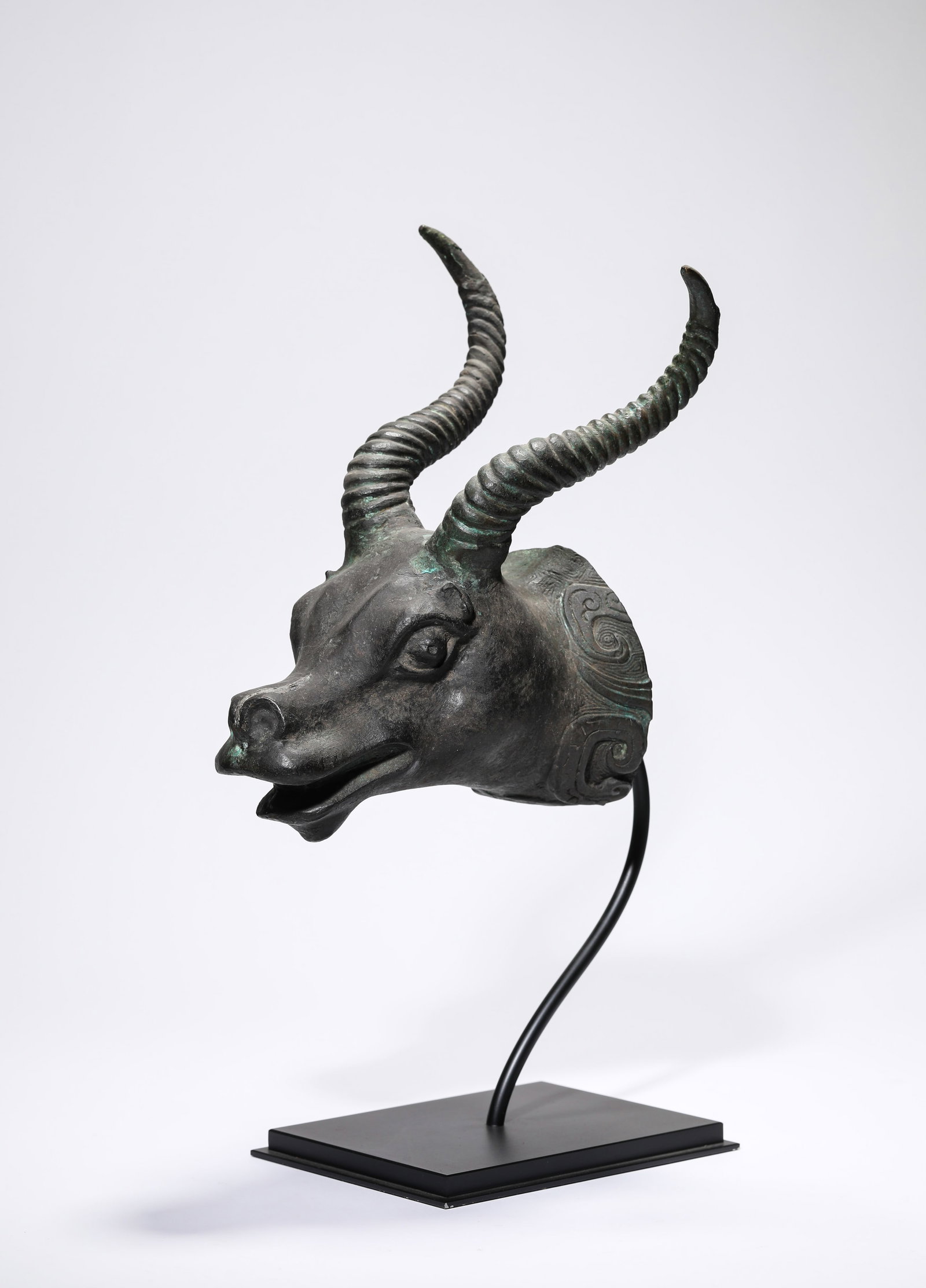 A BRONZE BEAST HEAD: A BRONZE BEAST HEAD Description: Dimensions: Weight: 1234 g. Length: 20.2 cm x Width: 16.8 cm x Height: 26.7 cm. All measurements are approximate.