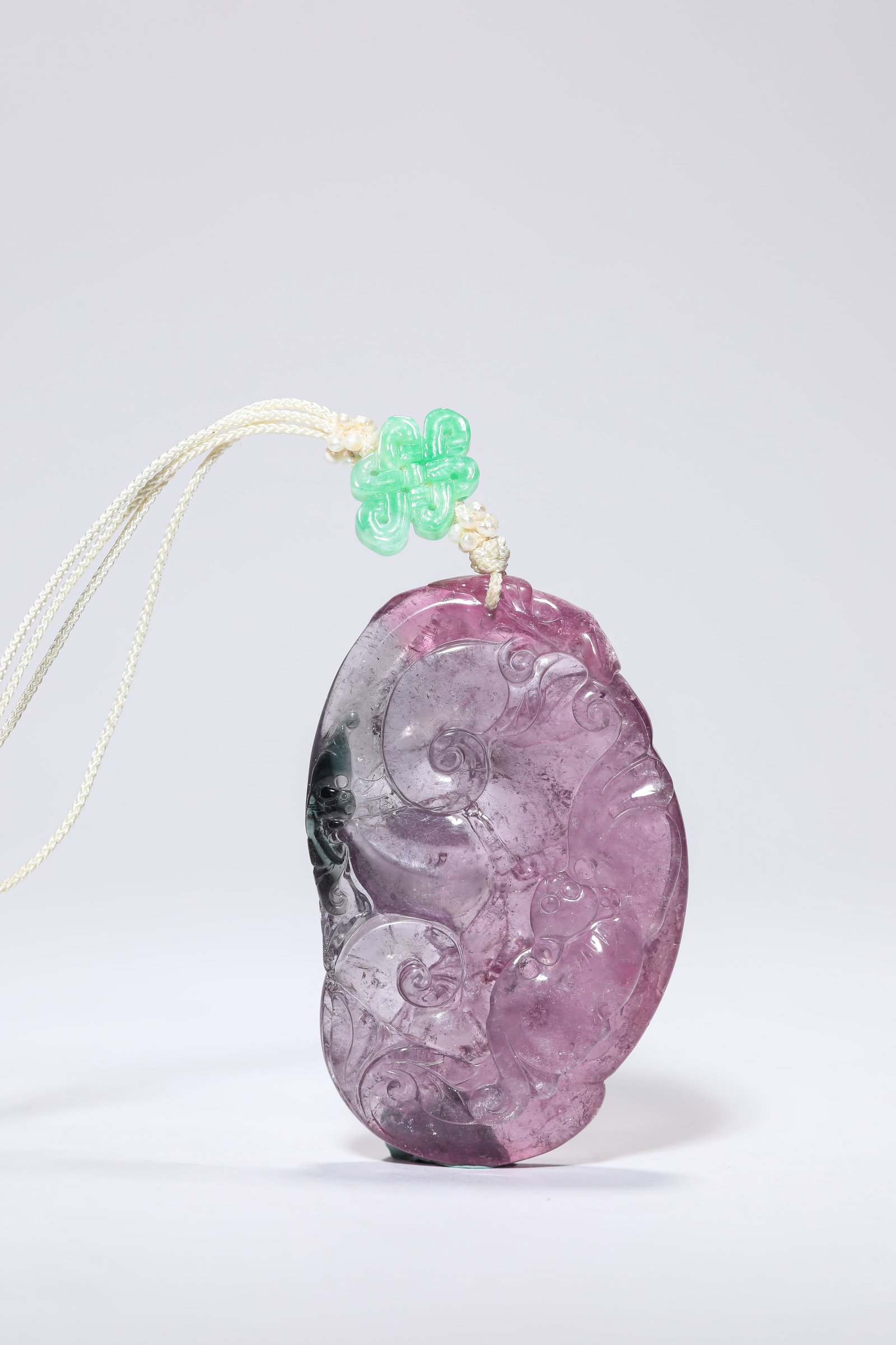 A TOURMALINE ‘CARVED LINGZHI’ PLAQUE: A TOURMALINE ‘CARVED LINGZHI’ PLAQUE Description: Dimensions: Width: 3.9 cm x Height: 6 cm. All measurements are approximate.