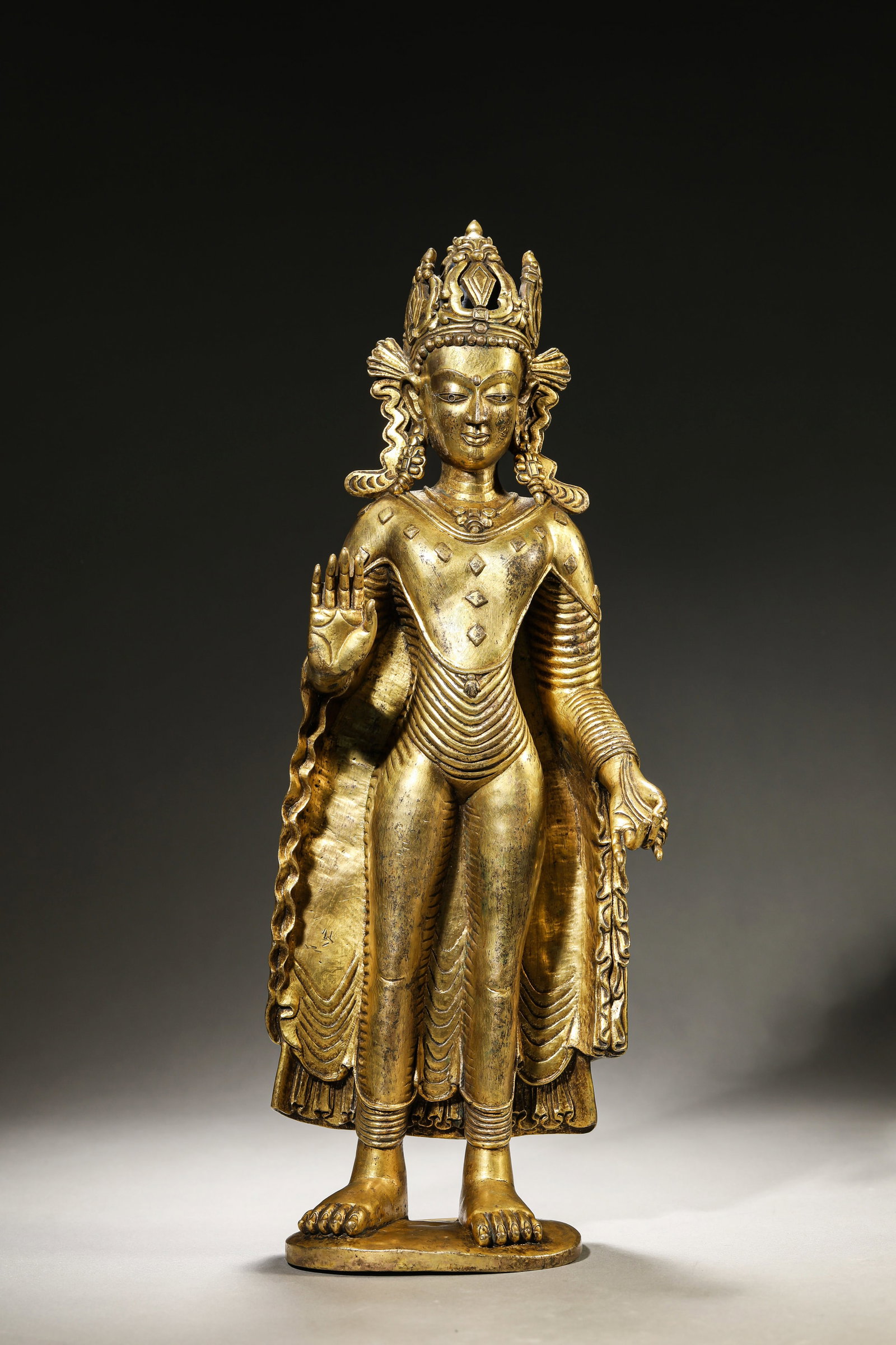 A TIBETAN GUGE KINGDOM-STYLE GOLD-CROWNED FIGURE OF SHAKYAMUNI: A TIBETAN GUGE KINGDOM-STYLE GOLD-CROWNED FIGURE OF SHAKYAMUNI Description: Dimensions: Weight: 4450 g. Length: 14 cm x Width: 8 cm x Height: 37.4 cm. All measurements are approximate.
