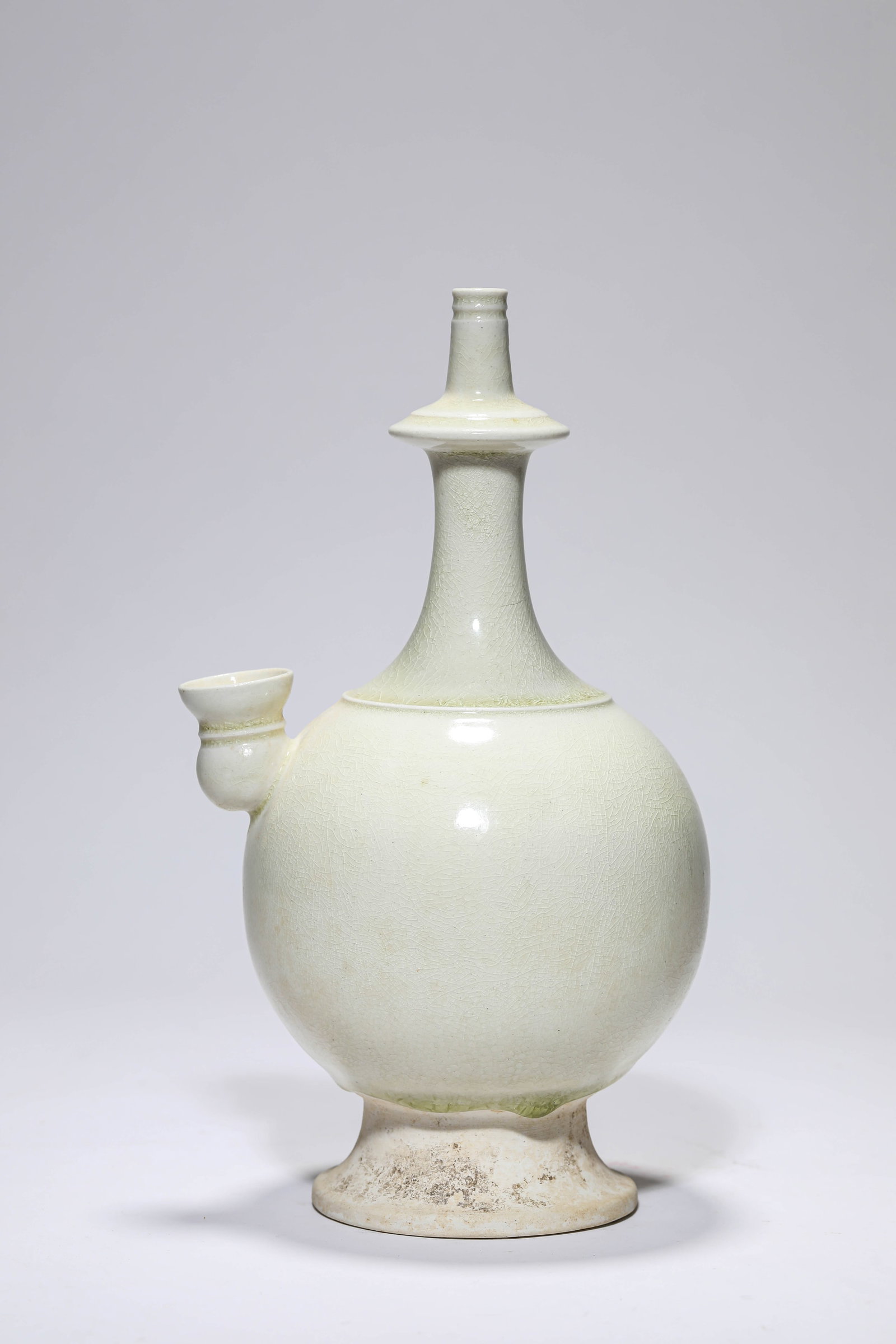 A WHITE PORCELAIN KUNDIKA: A WHITE PORCELAIN KUNDIKA Description: Dimensions: Length: 14.9 cm x Width: 13.2 cm x Height: 26.2 cm. All measurements are approximate.