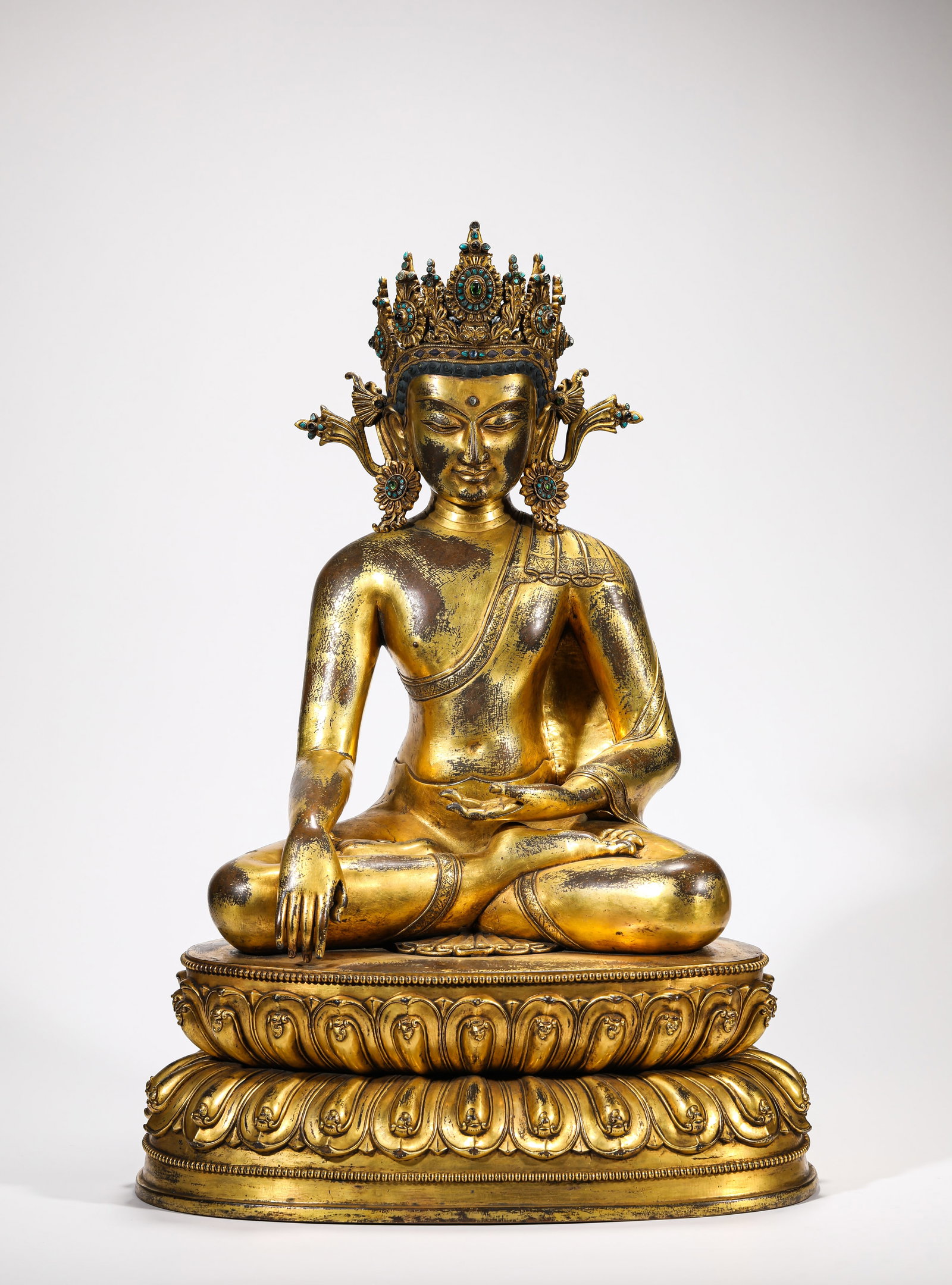 A MALLA-STYLE GEM-SET AND GOLD-CROWNED FIGURE OF SHAKYAMUNI: A MALLA-STYLE GEM-SET AND GOLD-CROWNED FIGURE OF SHAKYAMUNI Description: Dimensions: Weight: 19.95 g. Length: 40.8 cm x Width: 29.3 cm x Height: 58 cm. All measurements are approximate.