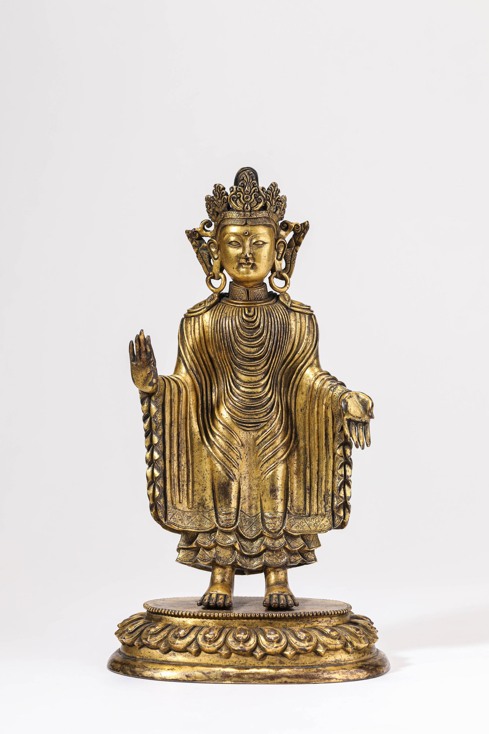 A GILT-BRONZE FIGURE OF THE SANDALWOOD BUDDHA: A GILT-BRONZE FIGURE OF THE SANDALWOOD BUDDHA Description: Dimensions: Weight: 1630 g. Length: 13 cm x Width: 8.9 cm x Height: 23.3 cm. All measurements are approximate.