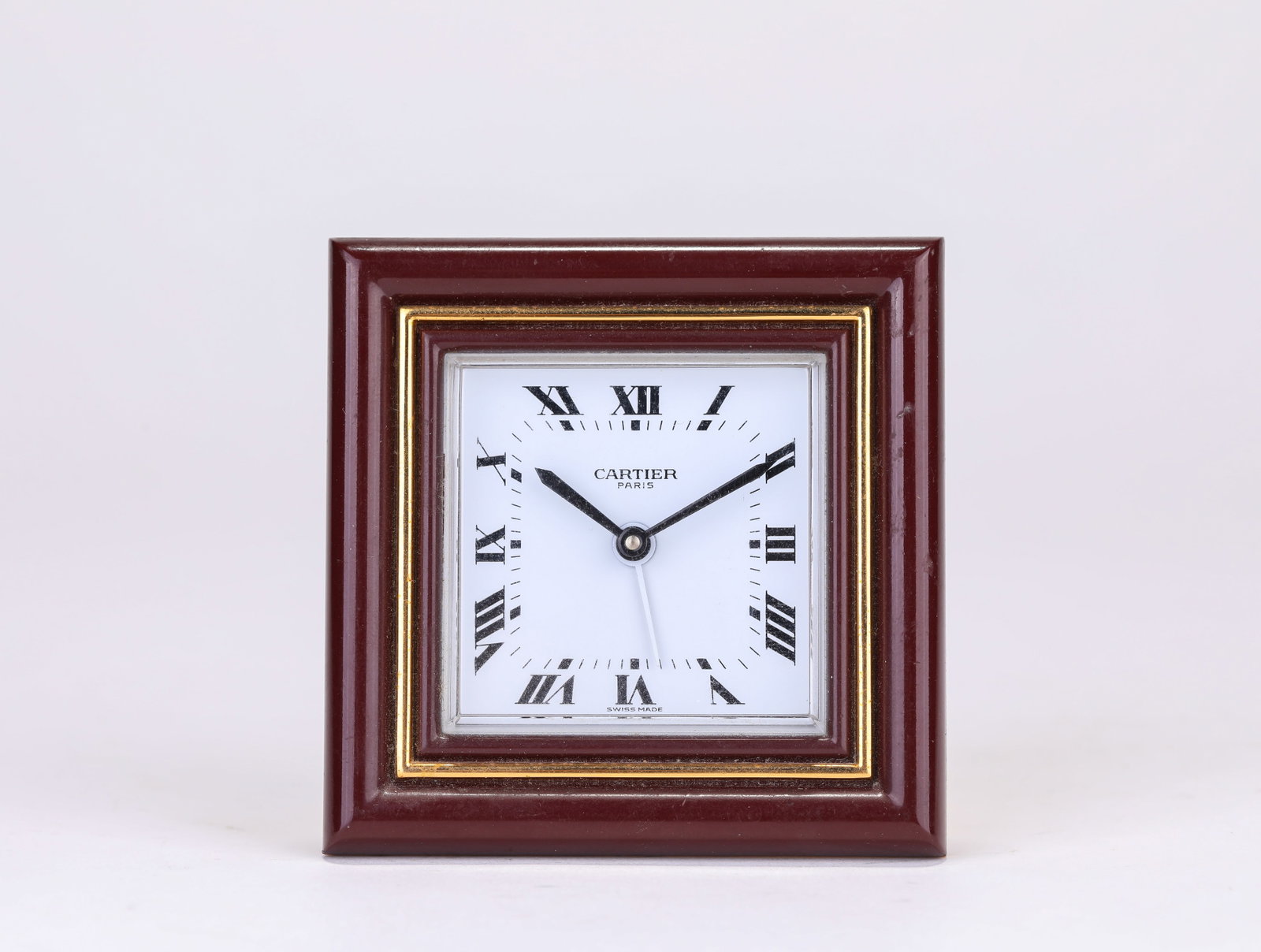 A CARTIER ALARM CLOCK: A CARTIER ALARM CLOCK Description: Dimensions: Weight: 232 g. Length: 7.5 cm x Width: 3.1 cm x Height: 7.6 cm. All measurements are approximate.