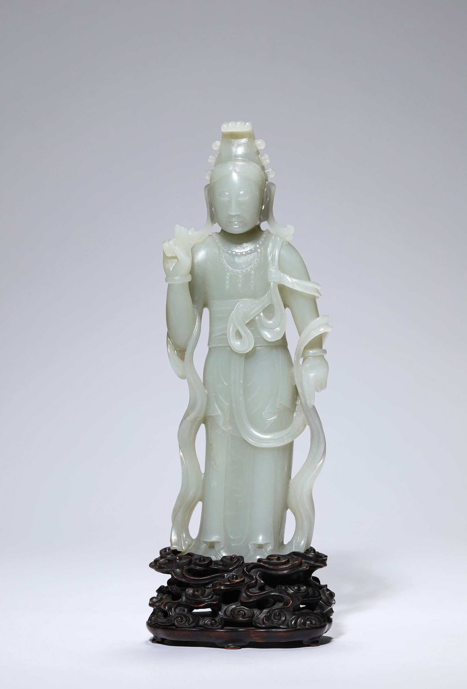 A JADE FIGURE OF AVALOKITESHVARA: A JADE FIGURE OF AVALOKITESHVARA Description: Dimensions: Length: 8.3 cm x Width: 4.5 cm x Height: 21.4 cm. All measurements are approximate.