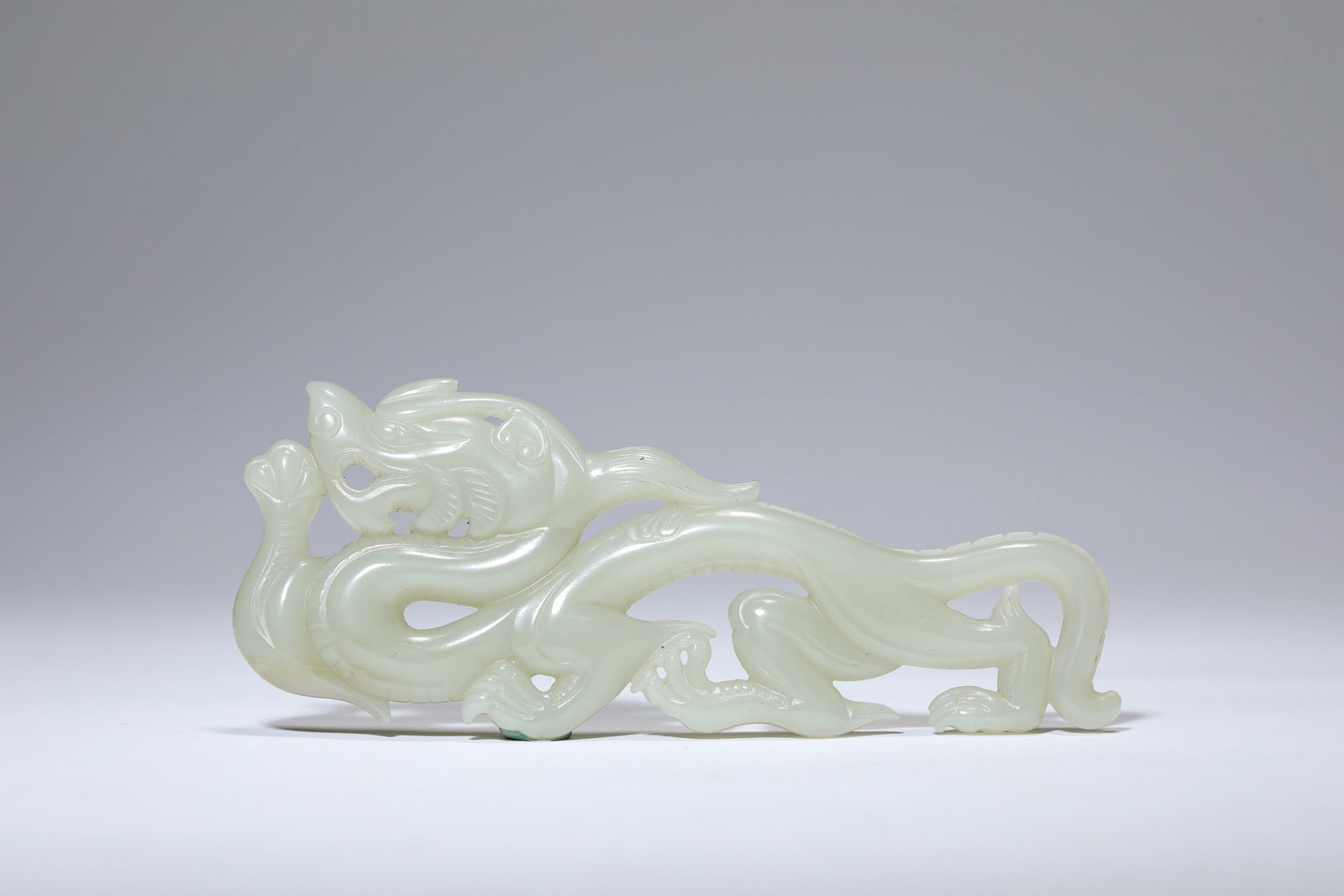 A JADE ‘DRAGON’ ORNAMENT: A JADE ‘DRAGON’ ORNAMENT Description: Dimensions: Length: 12.2 cm x Width: 1 cm x Height: 4.7 cm. All measurements are approximate.