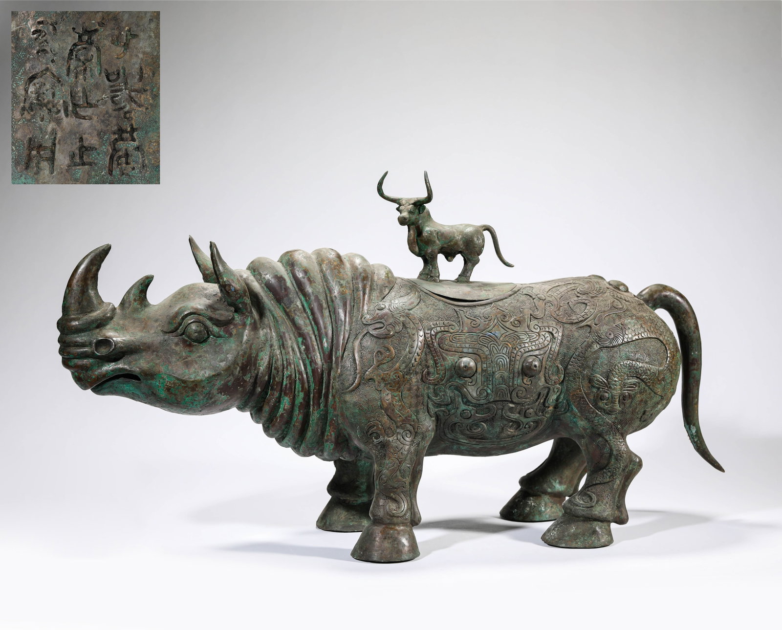 A BRONZE ‘RHINOCEROS-FORM’ ZUN: A BRONZE ‘RHINOCEROS-FORM’ ZUN Description: Dimensions: Weight: 11500 g. Length: 70 cm x Width: 21.6 cm x Height: 37 cm. All measurements are approximate.