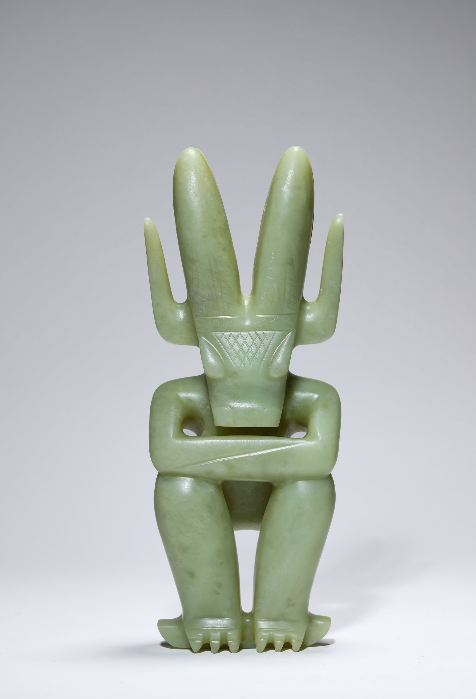 A JADE ‘SUN GOD’: A JADE ‘SUN GOD’ Description: Dimensions: Length: 11.7 cm x Width: 6.4 cm x Height: 29.5 cm. All measurements are approximate.