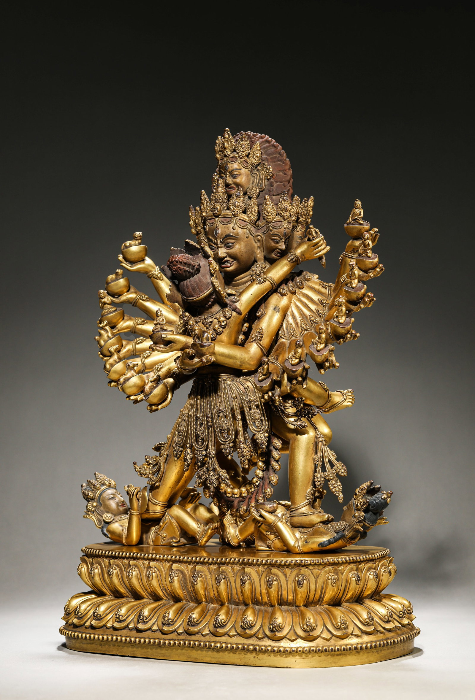 A TIBETAN COURT-STYLE FIGURE OF HEVAJRA: A TIBETAN COURT-STYLE FIGURE OF HEVAJRA Description: Dimensions: Weight: 15100 g. Length: 30.2 cm x Width: 19.2 cm x Height: 42.5 cm. All measurements are approximate.