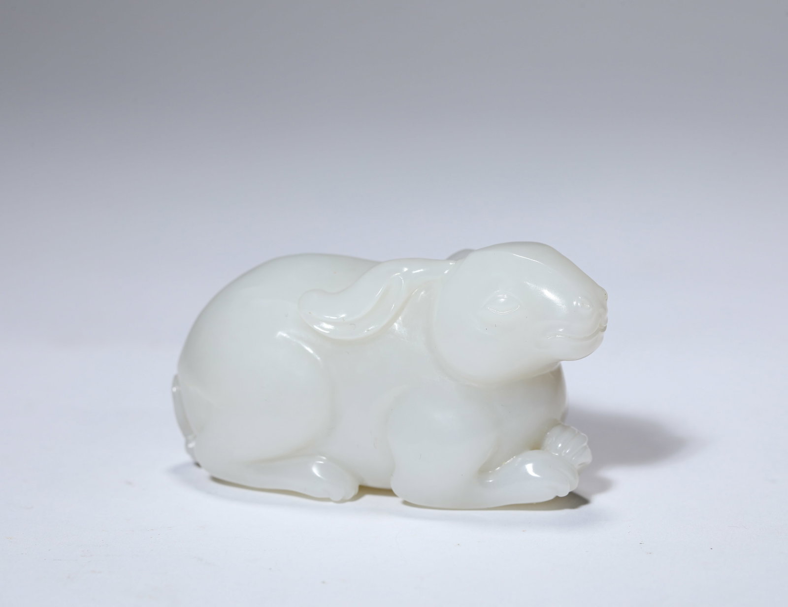 A JADE HARE: A JADE HARE Description: Dimensions: Length: 7.4 cm x Width: 3.5 cm x Height: 4.1 cm. All measurements are approximate.