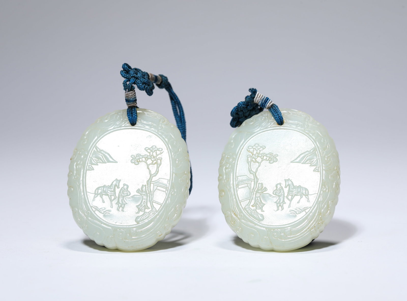 A PAIR OF JADE ‘NARRATIVE SCENE’ PLAQUES: A PAIR OF JADE ‘NARRATIVE SCENE’ PLAQUES Description: Dimensions: Width: 4.1 cm x Height: 5 cm. All measurements are approximate.