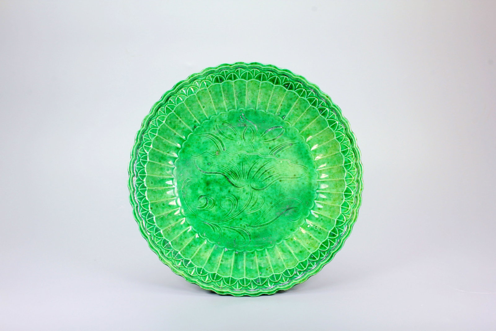A DINGYAO GREEN GLAZE CARVED DISH (1 of 7)