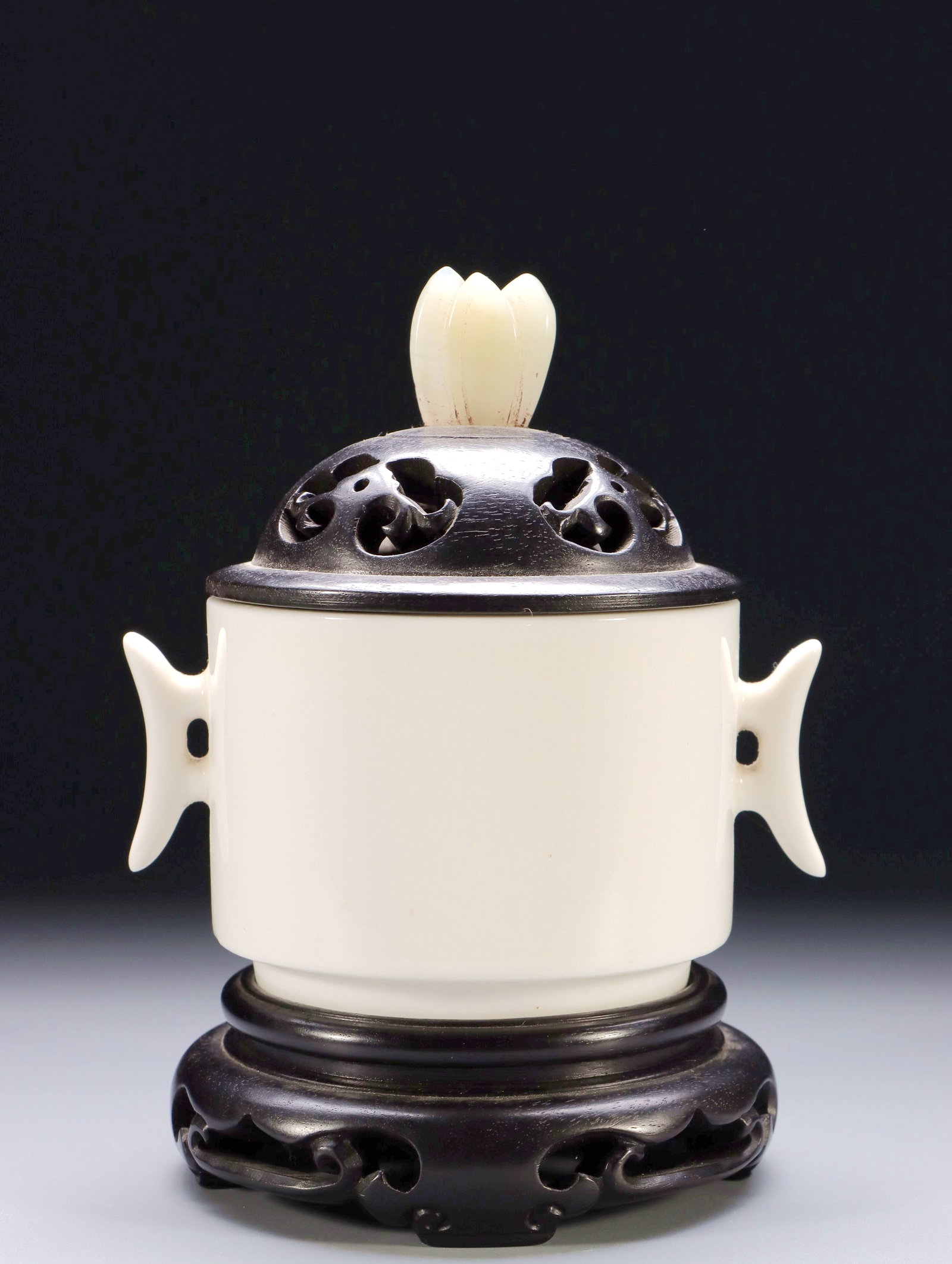 A DEHUA WHITE PORCELAIN AND HETIAN WHITE JADE TRIPOD CENSER WITH JADE KNOB AND AXE-HANDLE EARS (1 of 9)