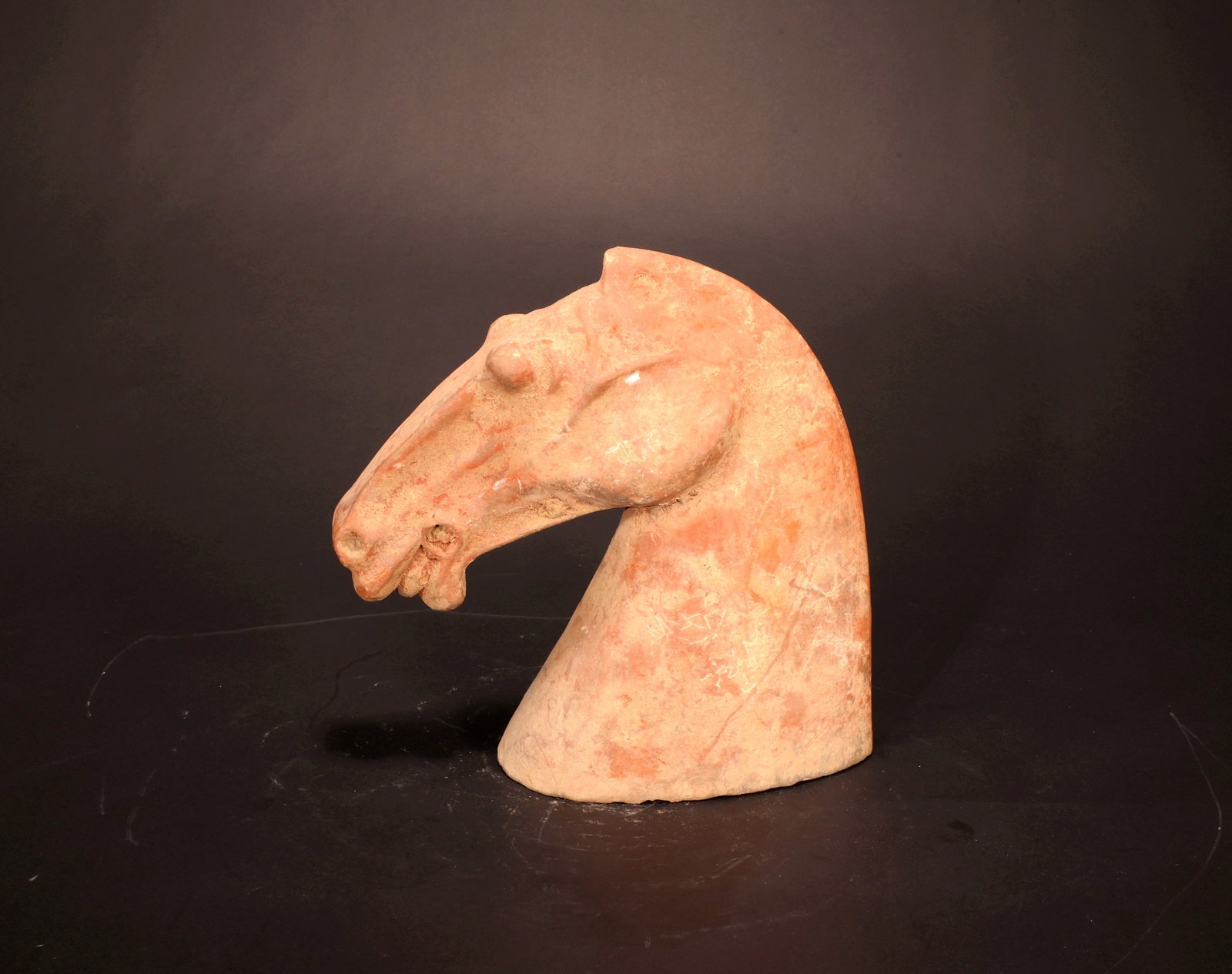 A RED POTTERY HORSE HEAD