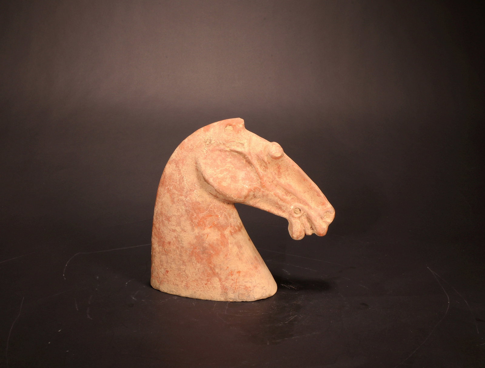 A RED POTTERY HORSE HEAD - 5