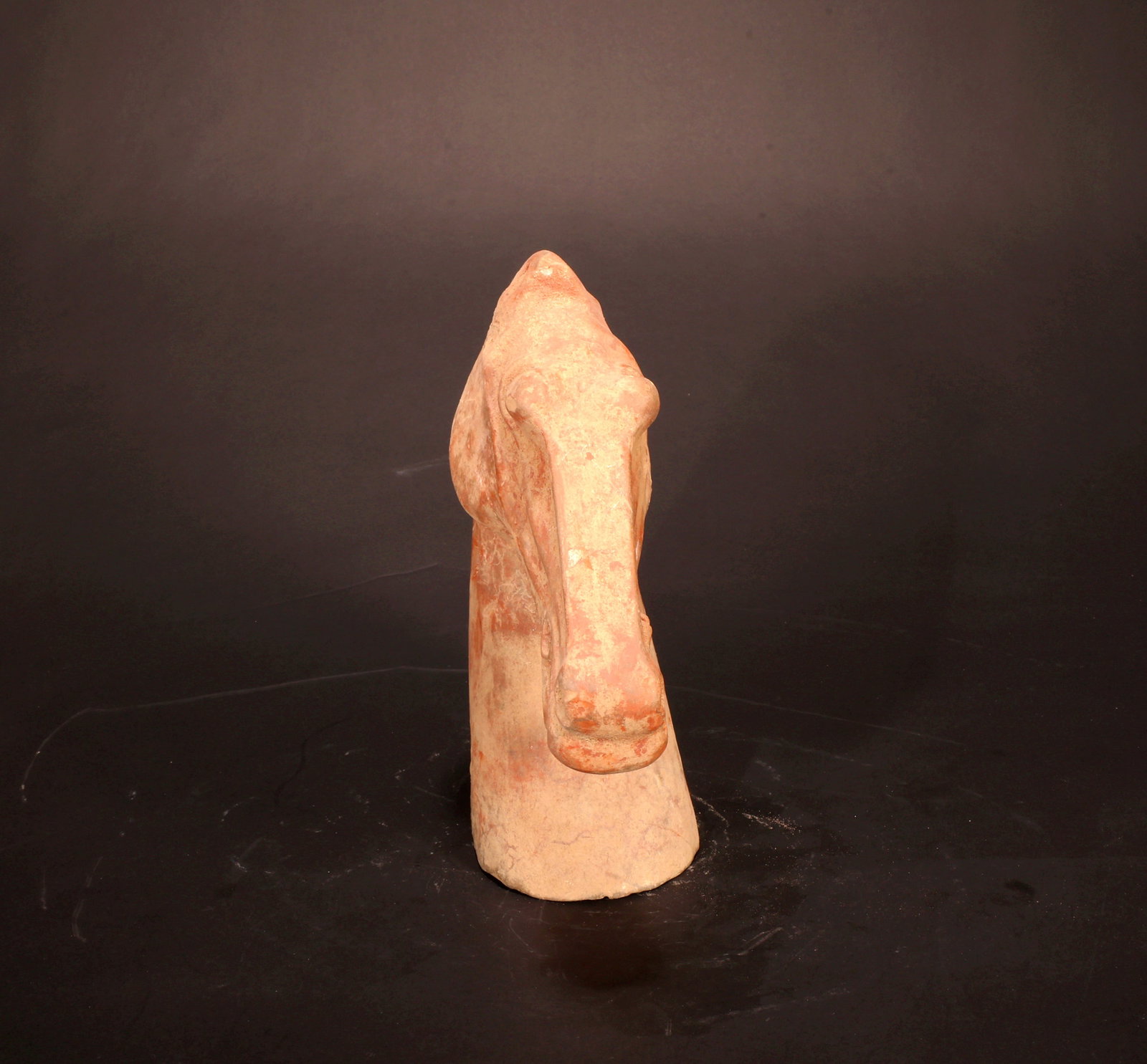 A RED POTTERY HORSE HEAD - 6
