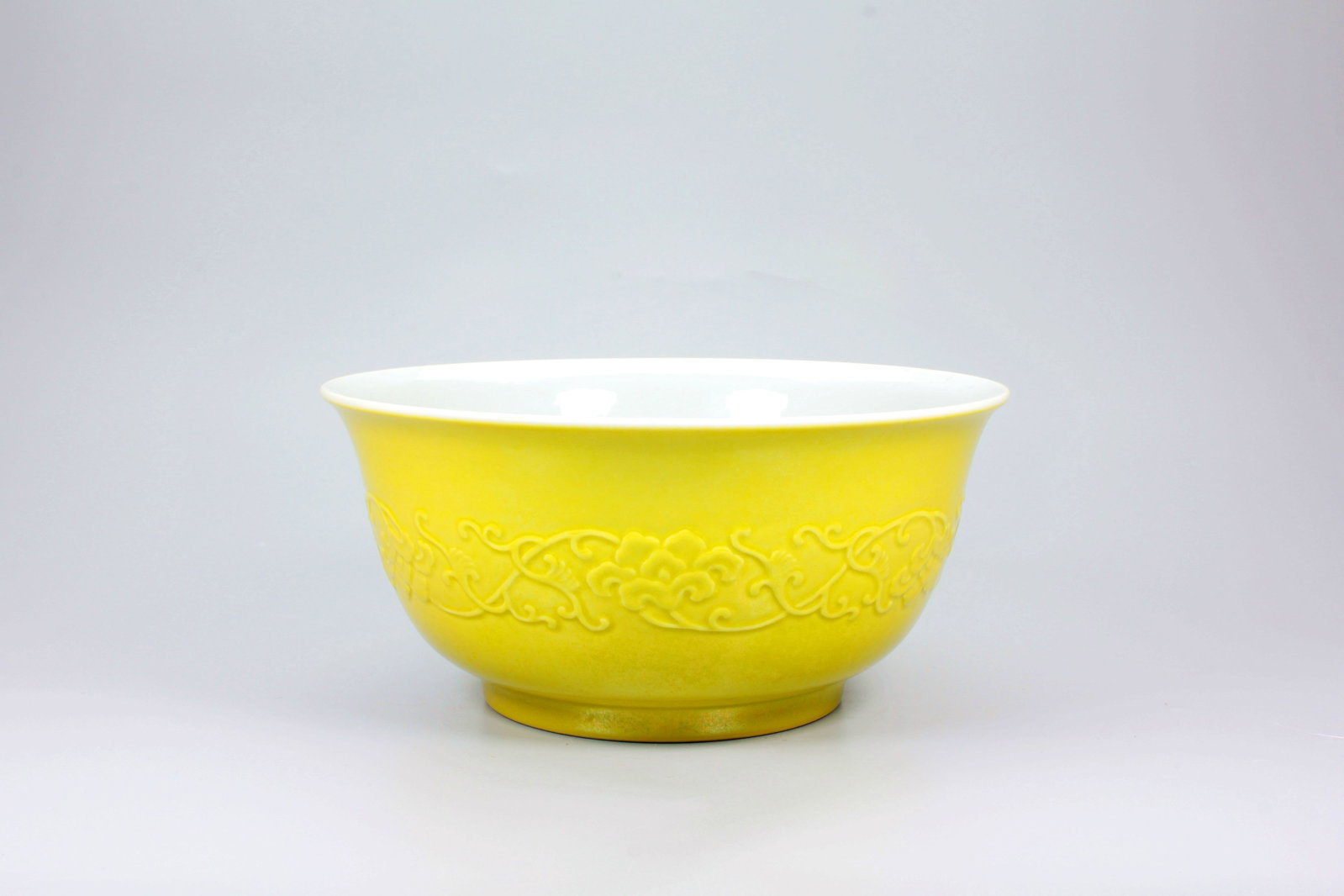 A LEMON YELLOW GLAZED CARVED INTERTWINED LOTUS WITH FAMILLE ROSE PEACH INTERIOR BOWL: A LEMON YELLOW GLAZED CARVED INTERTWINED LOTUS WITH FAMILLE ROSE PEACH INTERIOR BOWL H:8.7CM,D:18.4CM