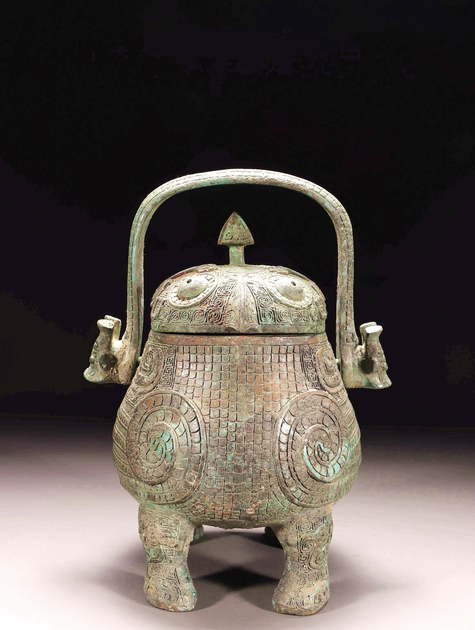 A BRONZE BIRD-SHAPED YOU VESSEL WITH LOOP HANDLE (1 of 10)