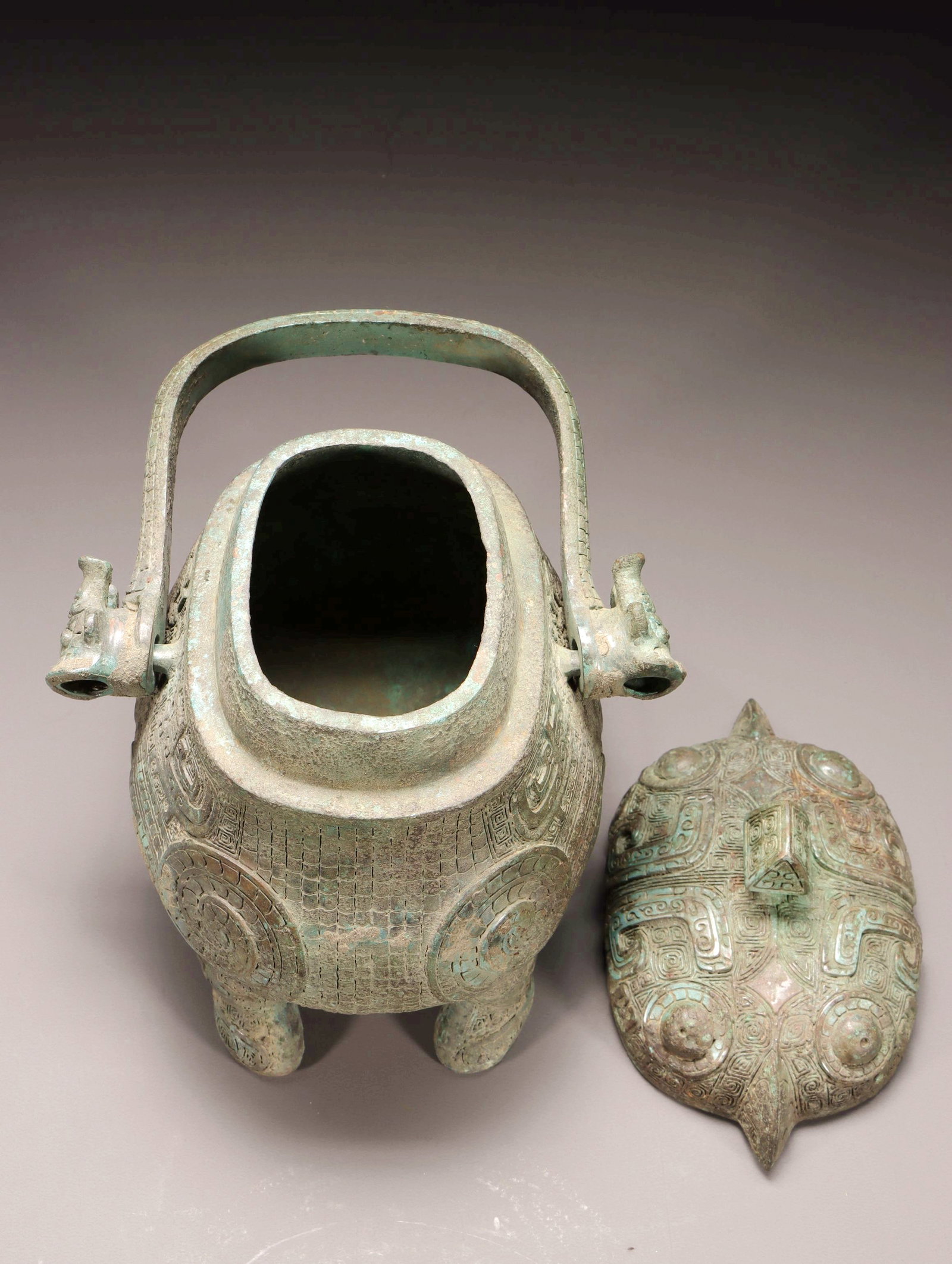 A BRONZE BIRD-SHAPED YOU VESSEL WITH LOOP HANDLE - 8