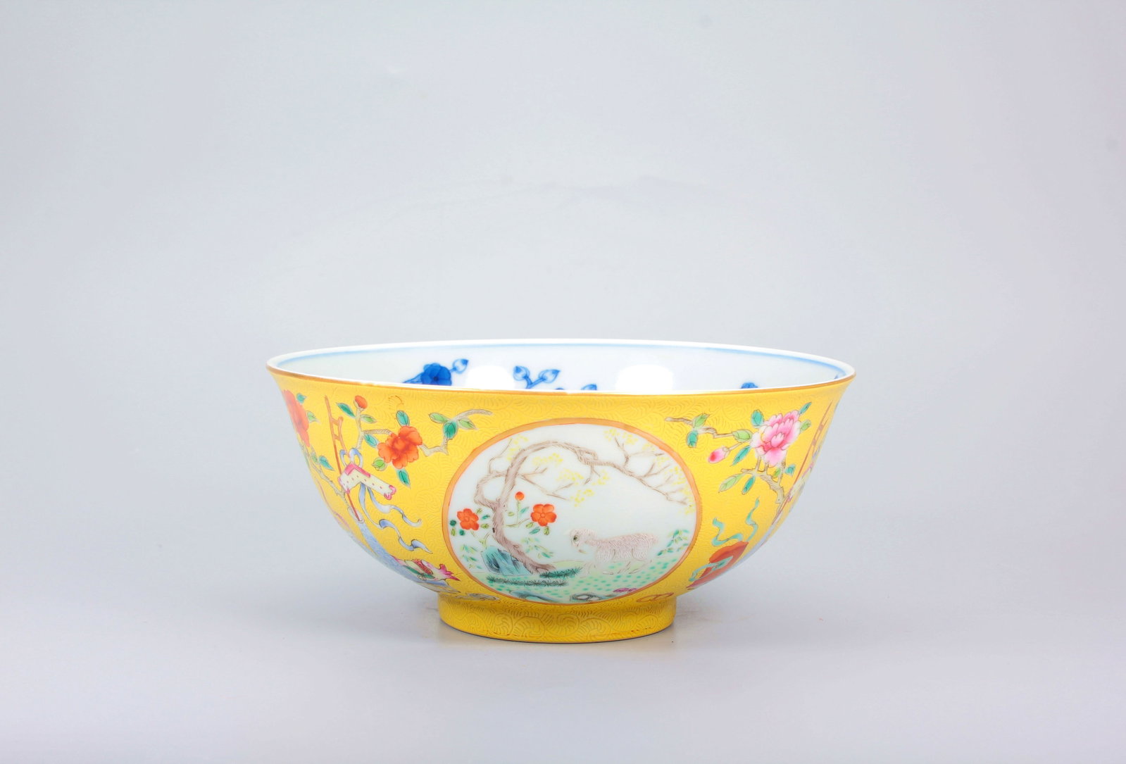 A BLUE AND WHITE INTERIOR WITH EXTERIOR FENCED OPENWORK FAMILLE ROSE THREE RAMS PROSPERITY BOWL: A BLUE AND WHITE INTERIOR WITH EXTERIOR FENCED OPENWORK FAMILLE ROSE THREE RAMS PROSPERITY BOWL H:7.2CM,D:15CM