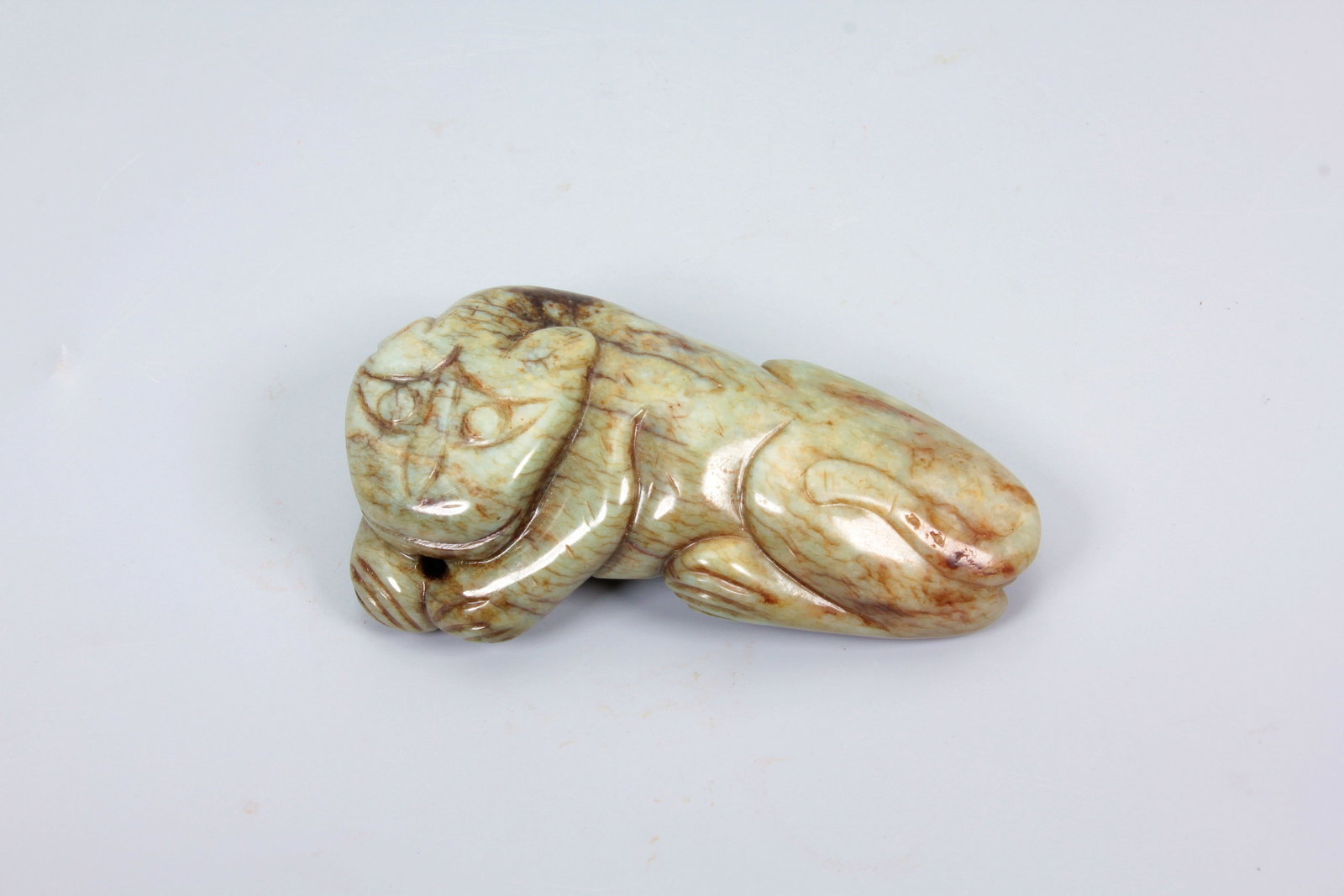 A HETIAN JADE TIGER ORNAMENT: A HETIAN JADE TIGER ORNAMENT H:2.5CM,L:4.7CM,W:8.5CM
